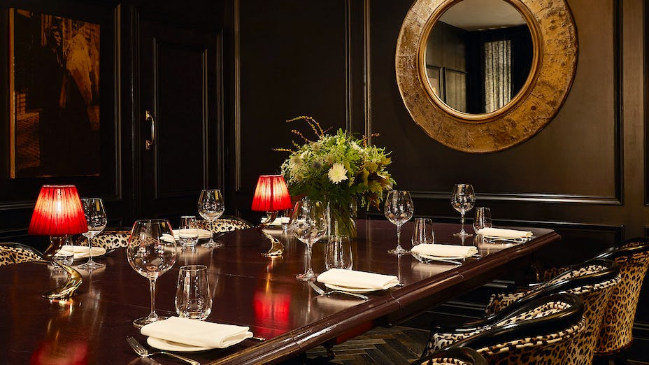Elegant private dining room with floral centerpiece for exclusive events and intimate meetings.