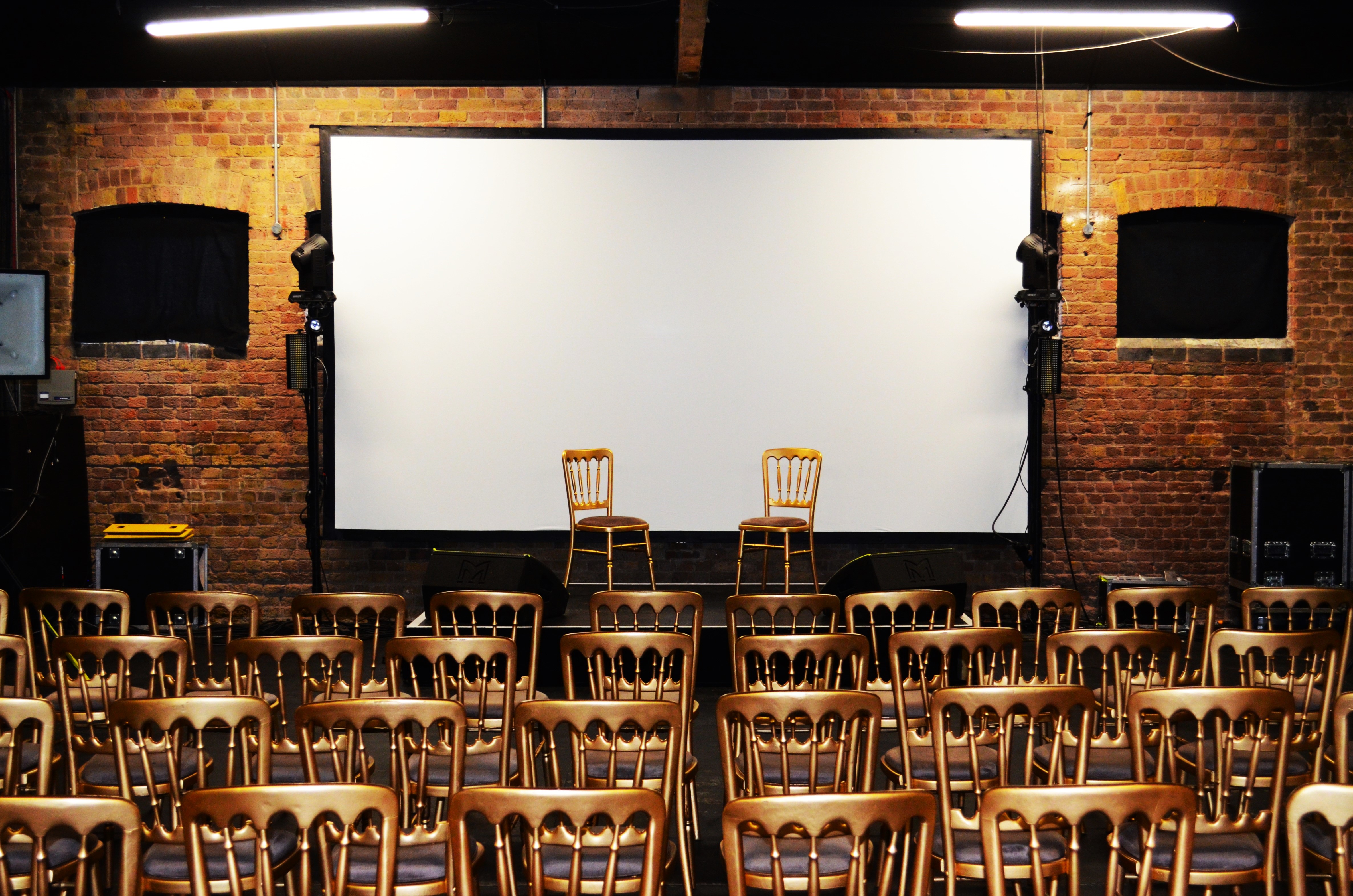 Event space at The Warehouse, Camden with projection screen for workshops and discussions.