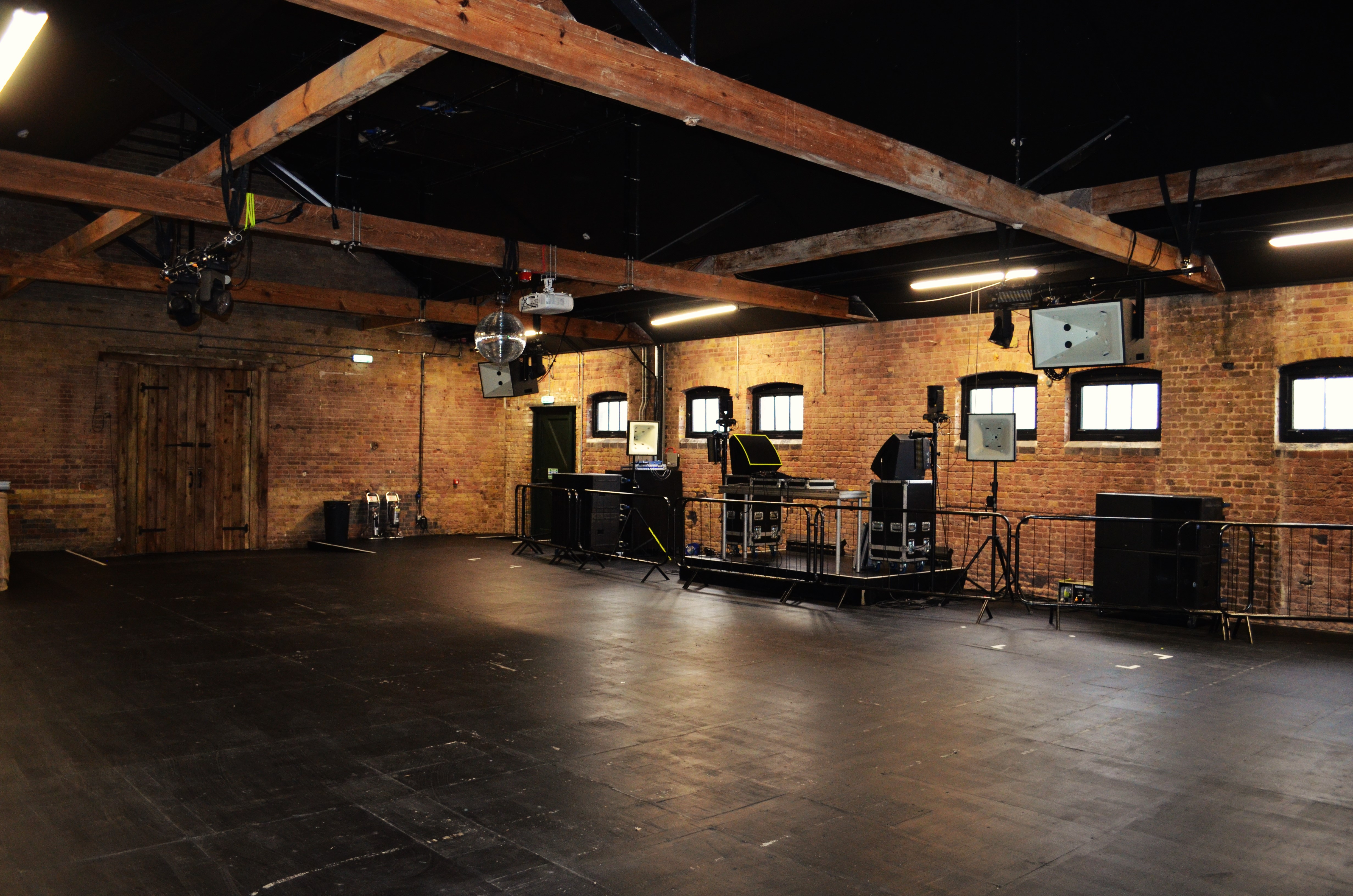 Versatile event space with exposed brick walls in Camden for meetings and gatherings.