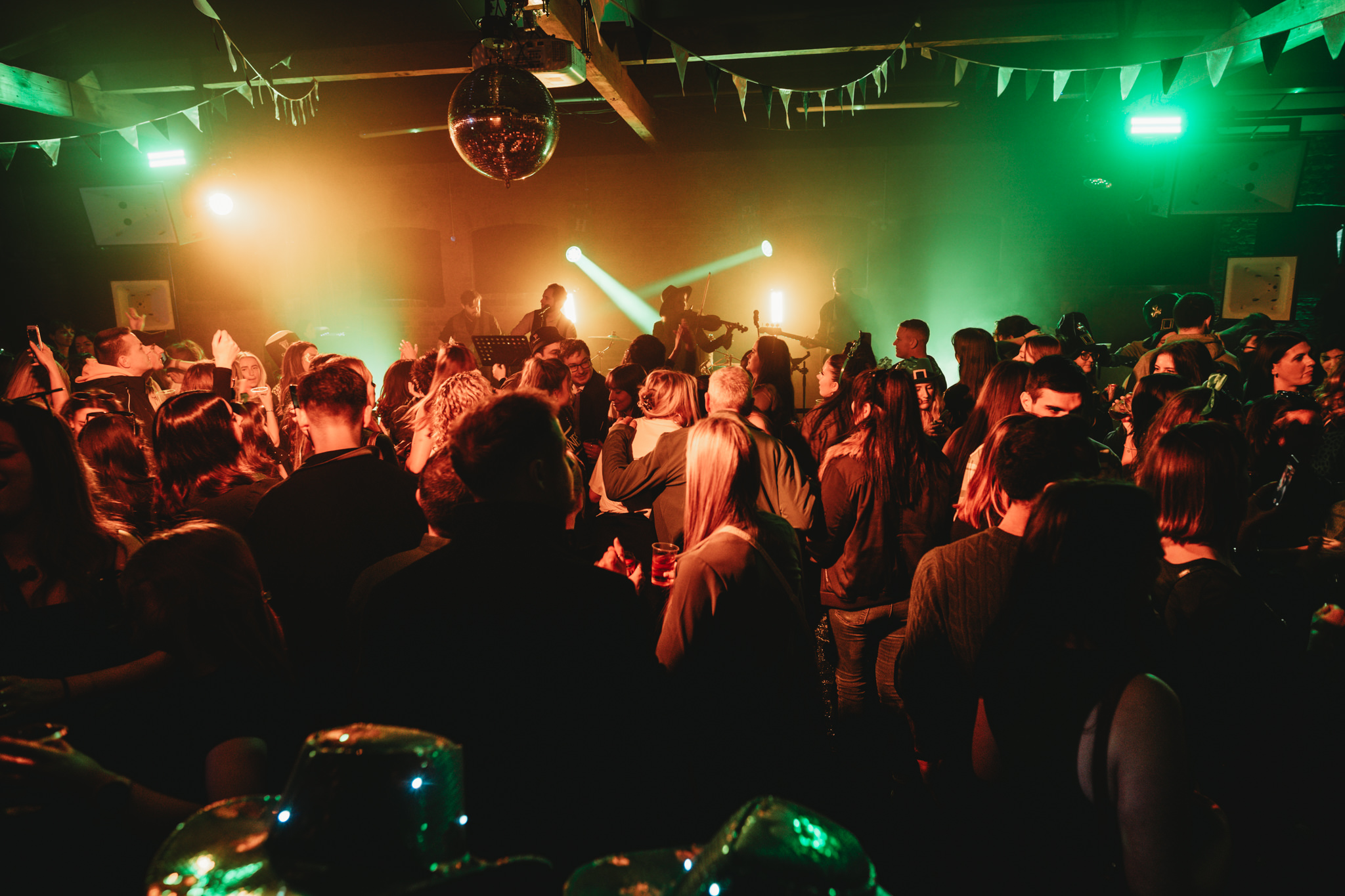 Vibrant event at The Warehouse, Camden with dynamic lighting and disco ball ambiance.