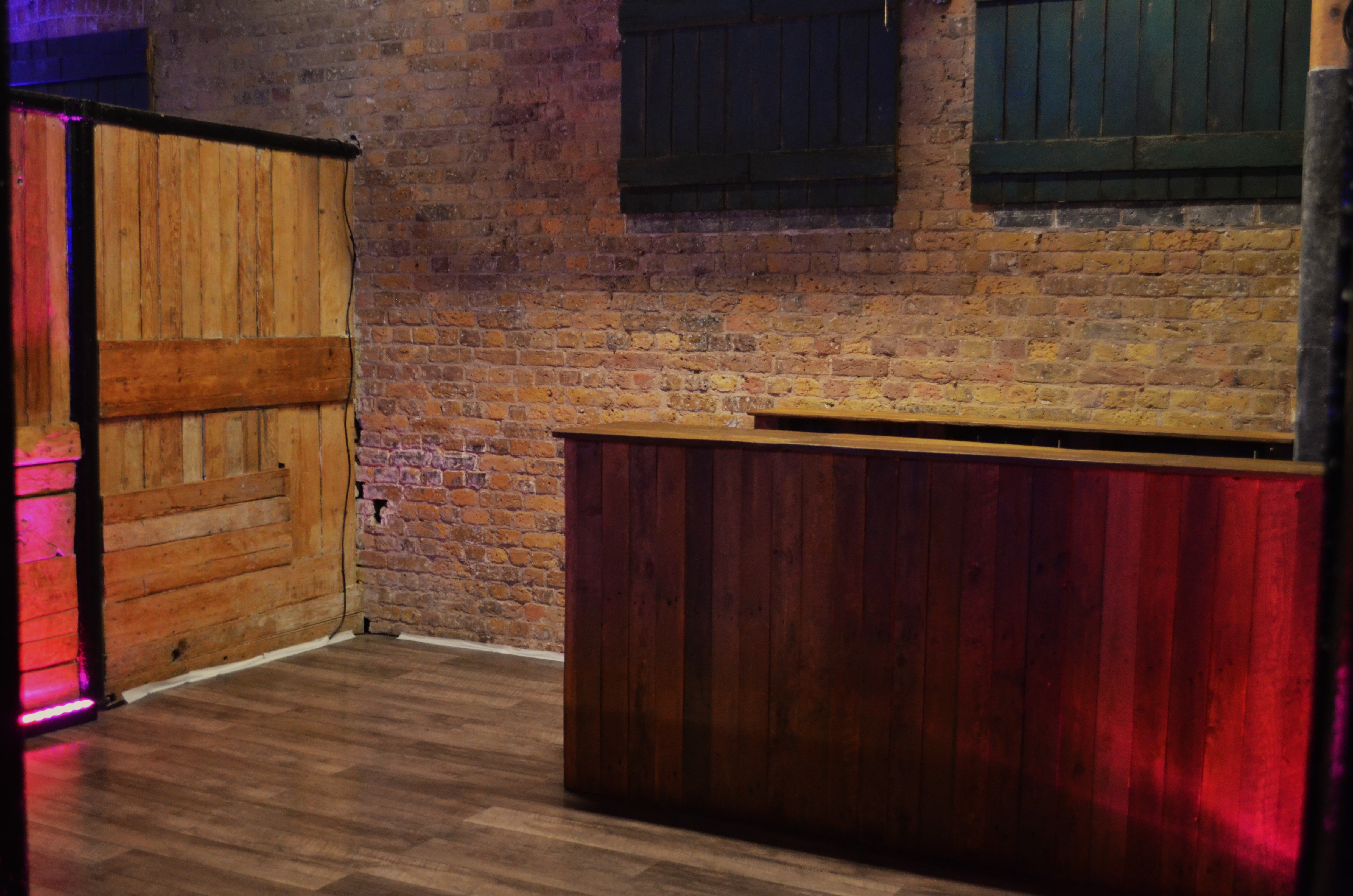 Versatile event space in Camden with rustic bar and exposed brick walls for gatherings.