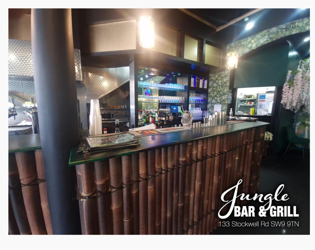 Vibrant Jungle Bar & Grill with bamboo counter, ideal for events and gatherings.