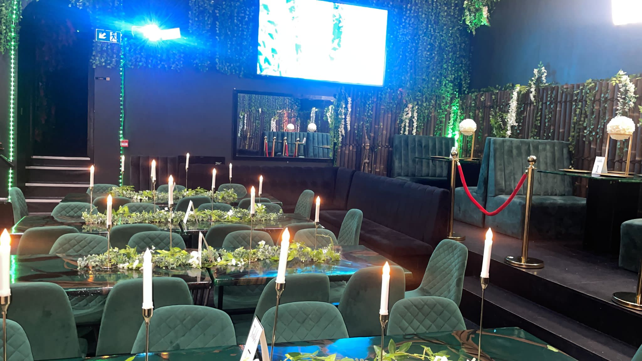 Elegant event space at Jungle Bar & Grill with greenery, ideal for corporate gatherings.