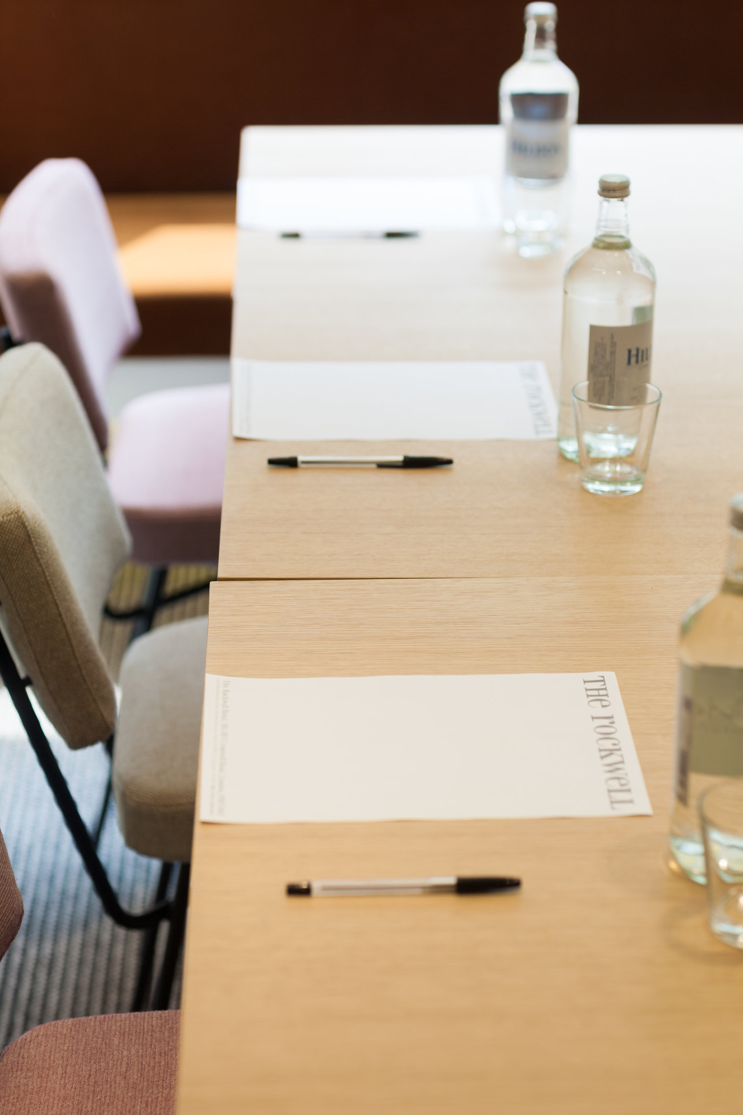 The Rockwell Meeting Room with a wooden table, ideal for professional conferences.