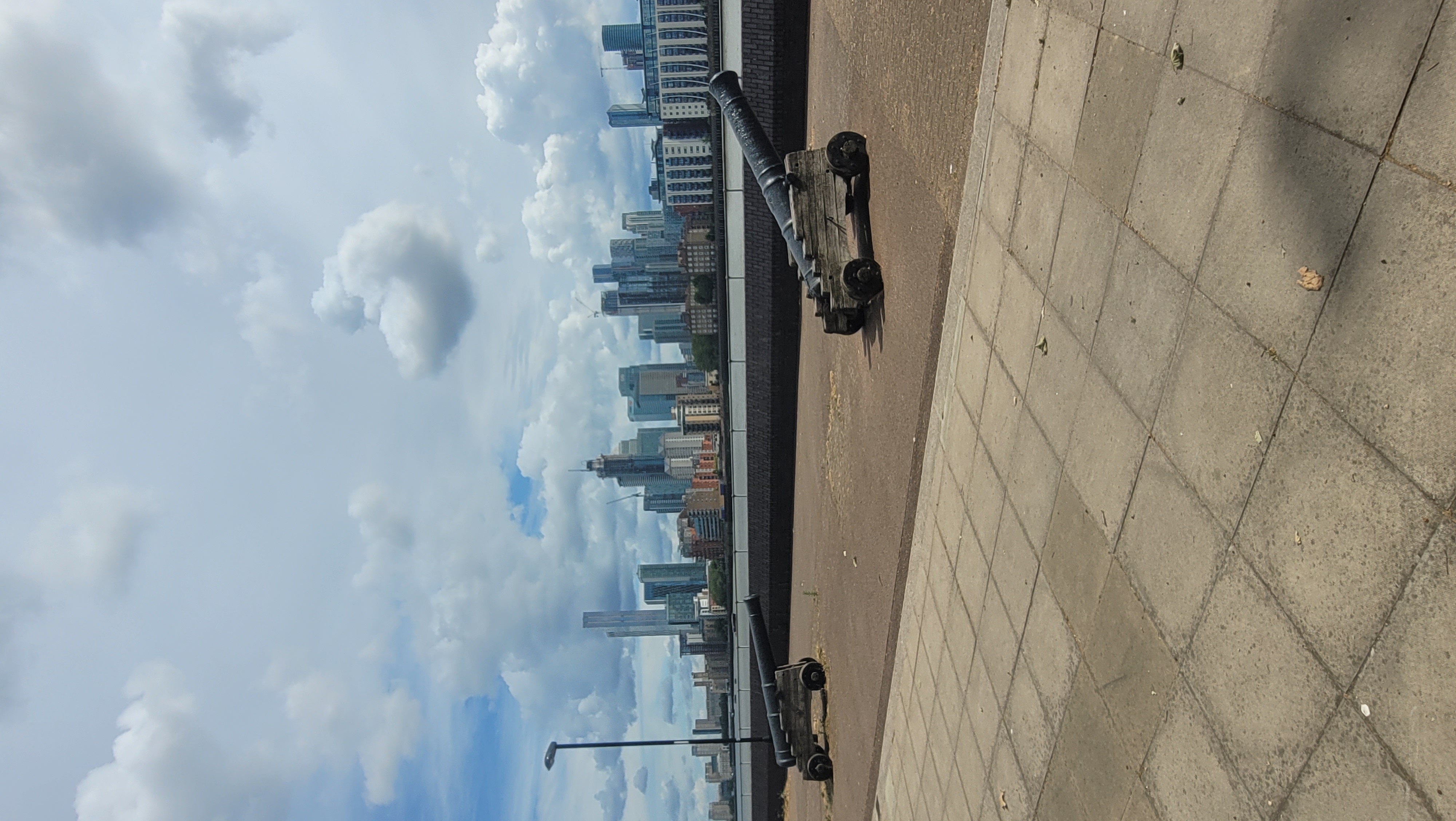 Basement venue with historical cannons and modern skyline, perfect for events.