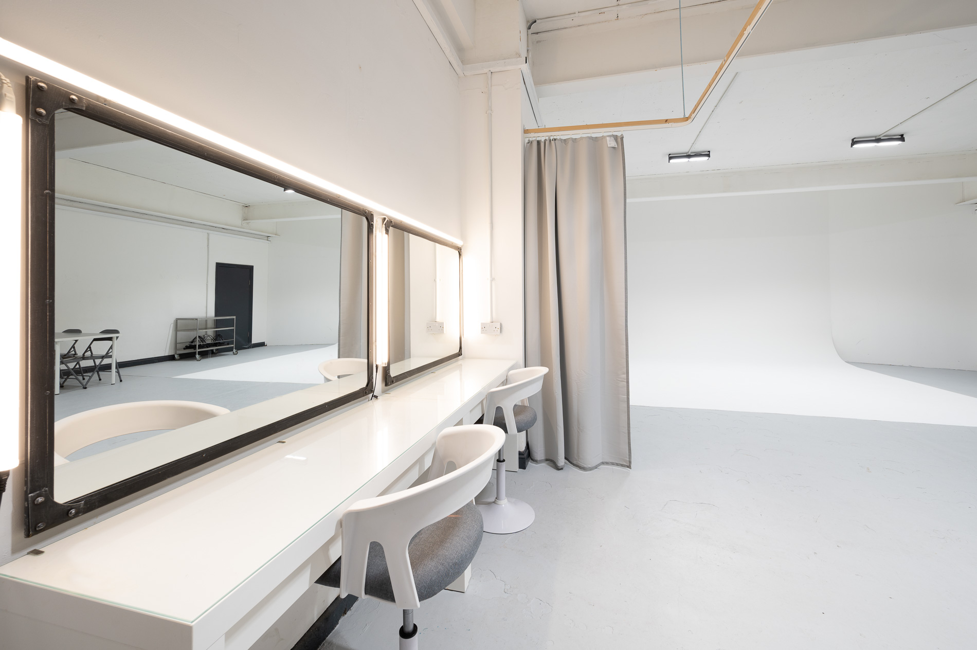 Sleek minimalist event preparation space with well-lit vanity at 69 Drops Studios.