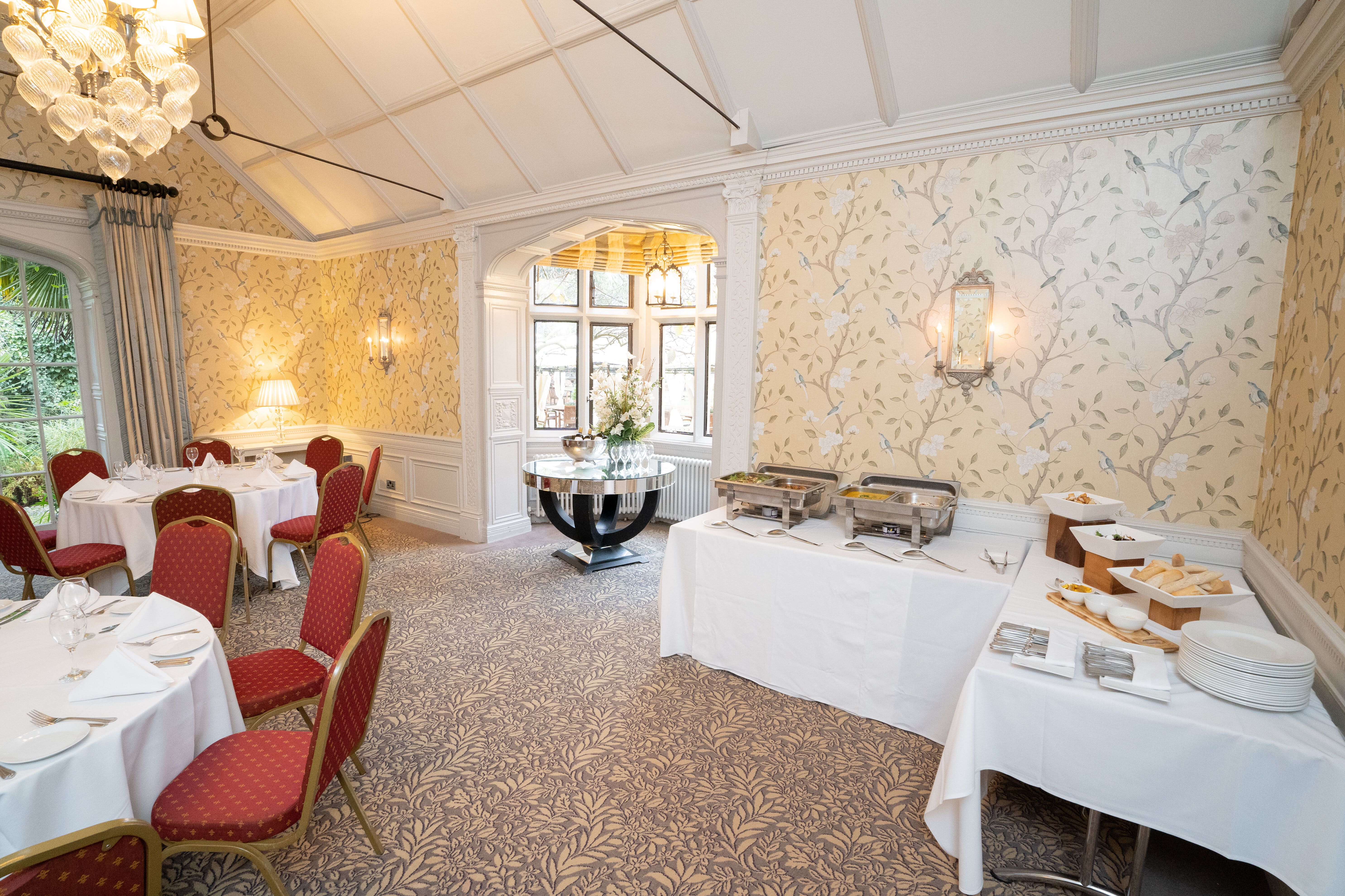 Elegant event space at Four Seasons Warren House Hotel with round tables and buffet setup.