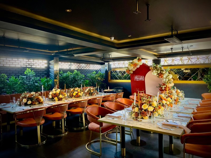 Elegant dining space with floral centerpieces for upscale events and corporate dinners.