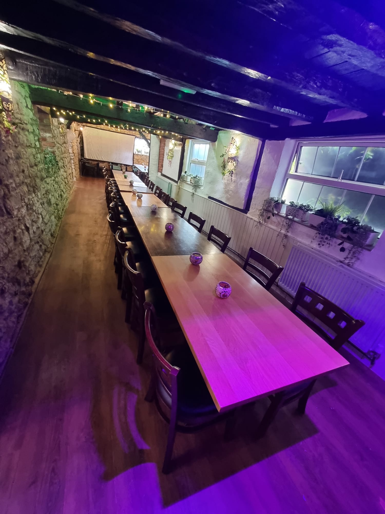 Elegant meeting space at Casbah Restaurant with wooden tables, ideal for workshops.