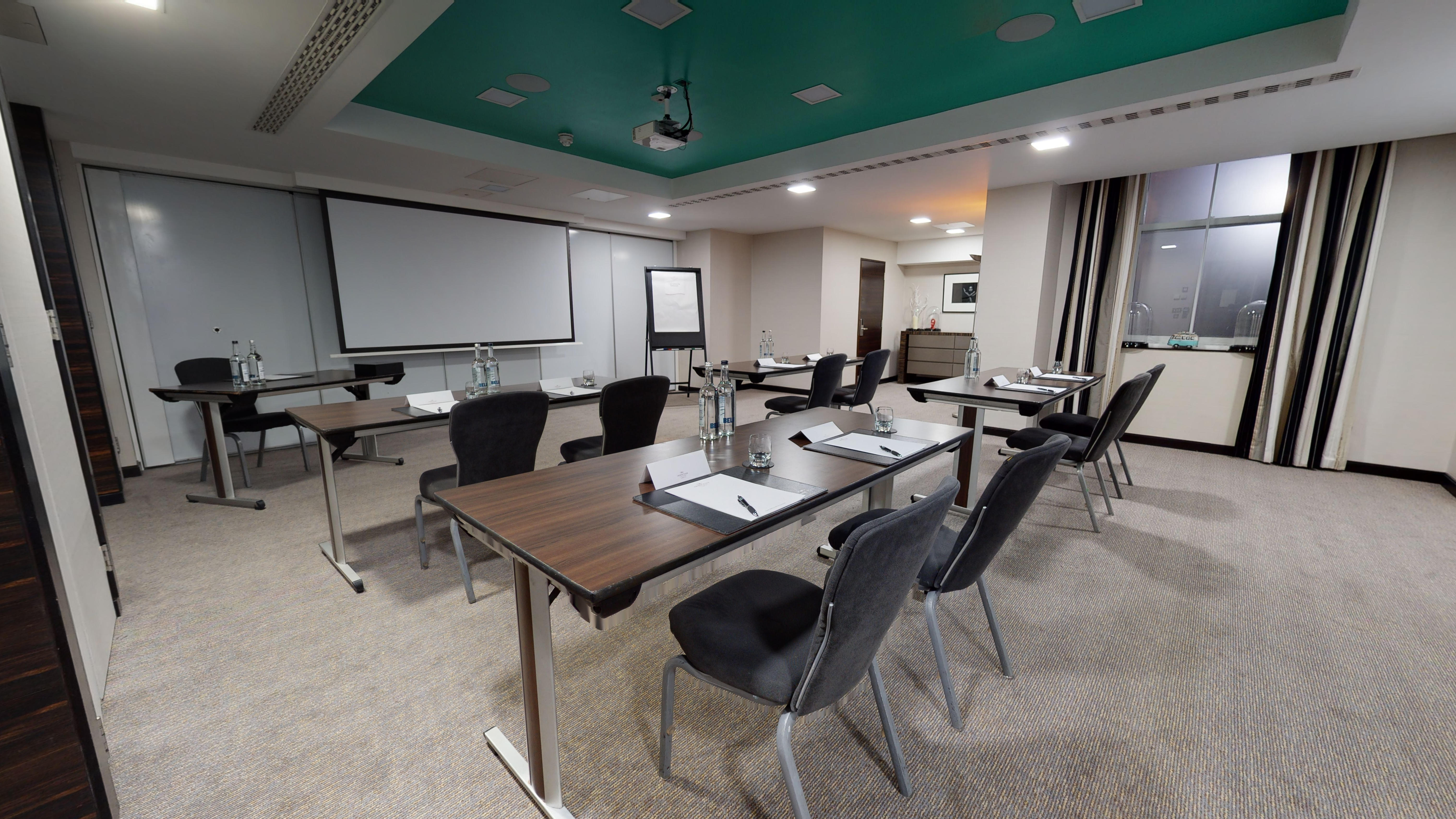 Cromwell 2 meeting room at DoubleTree London, featuring tables for professional events.