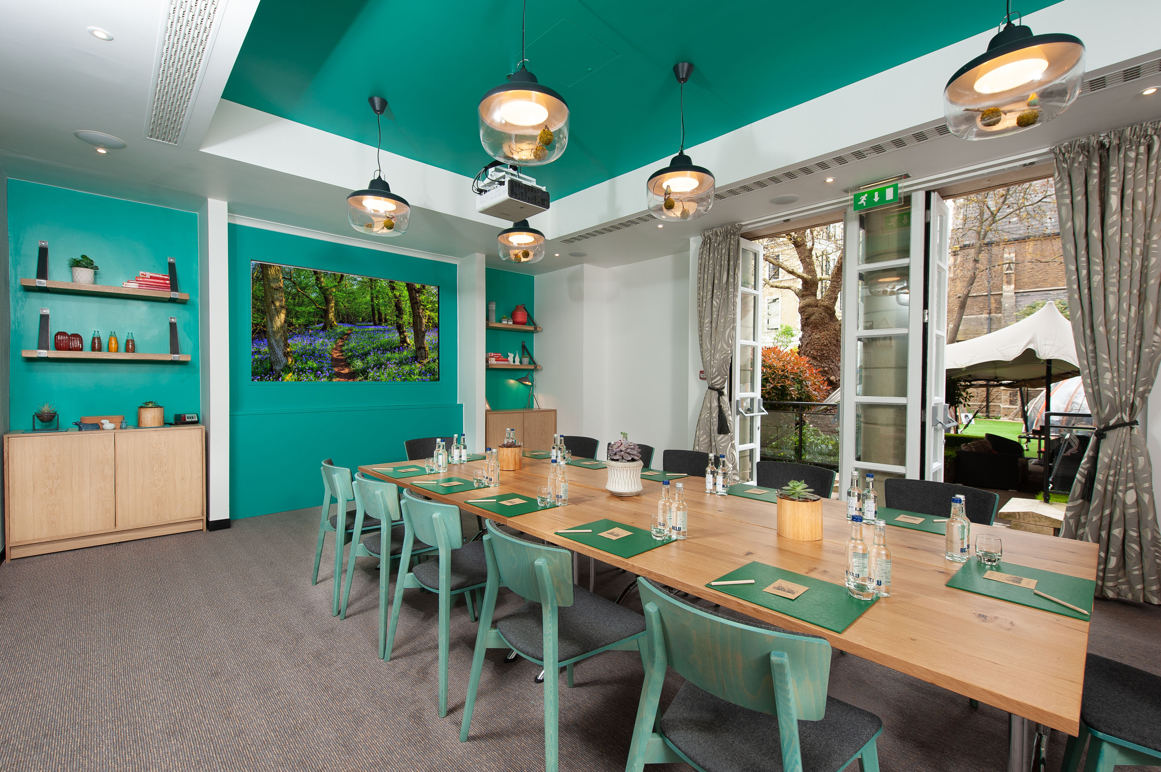 Modern meeting room with wooden table, ideal for workshops at DoubleTree London Kensington.