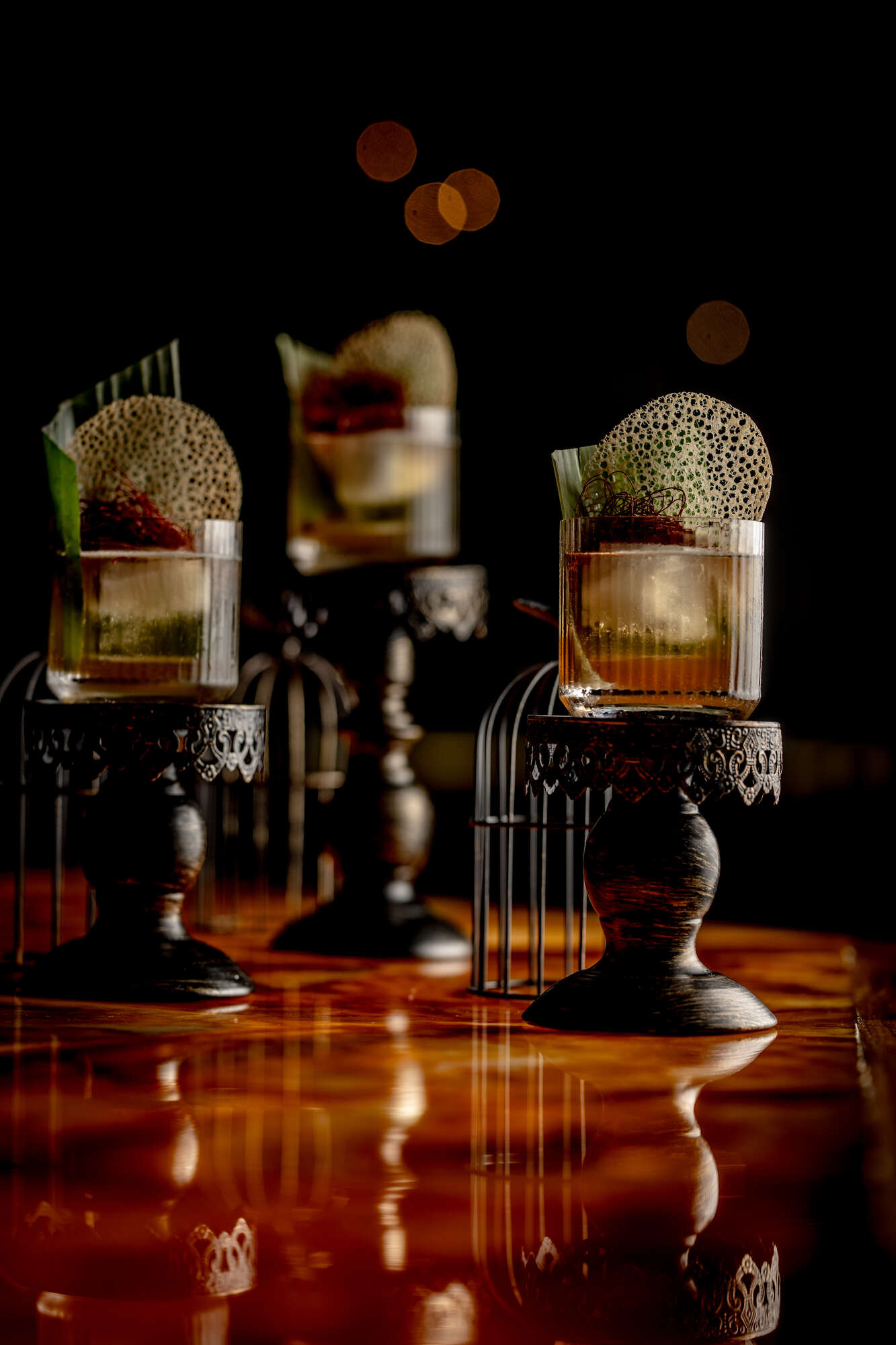 Elegant cocktails on ornate stands at Smith's Cocktail Bar for upscale events.