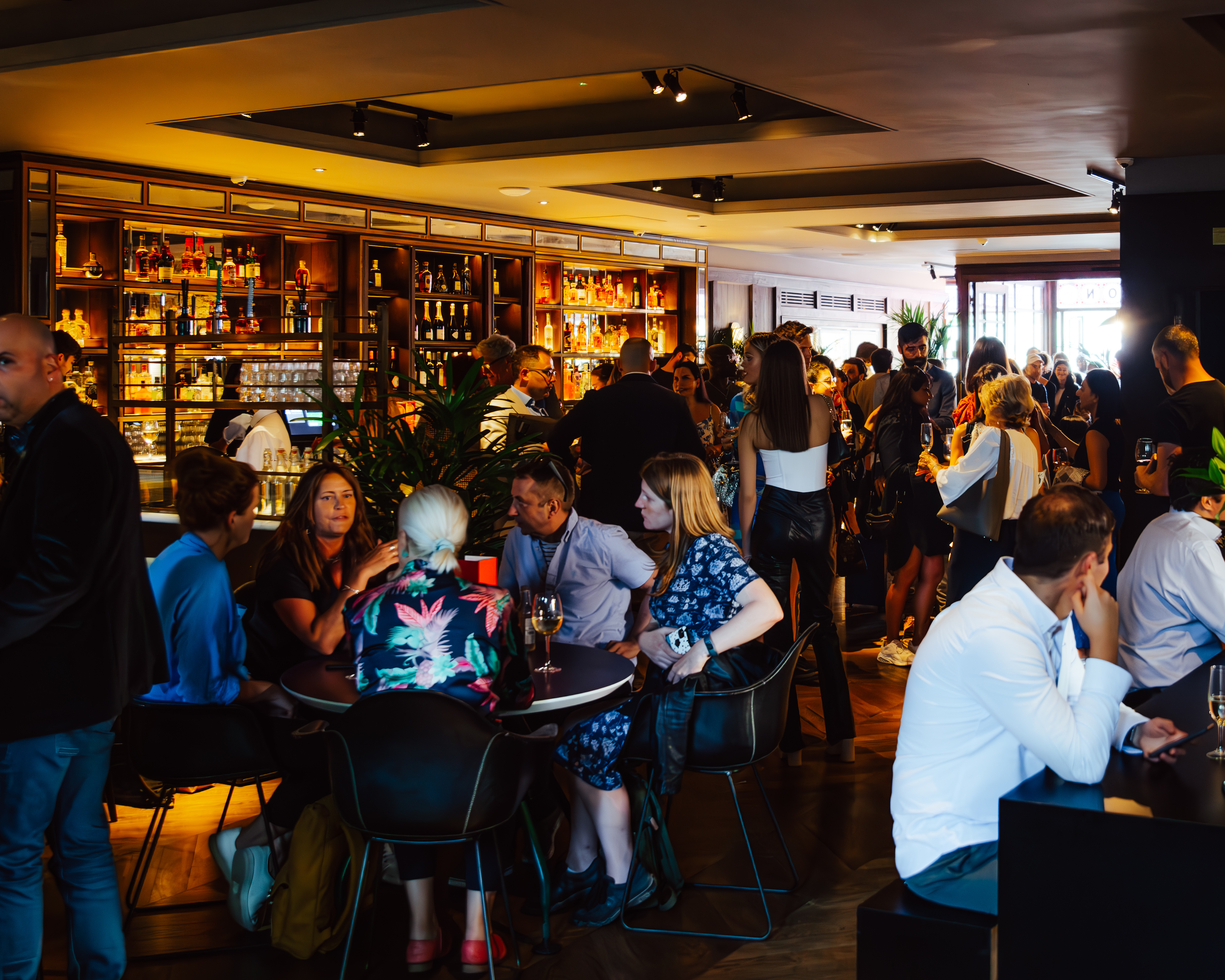 Vibrant networking event at NEON194 bar with modern decor and engaged attendees.