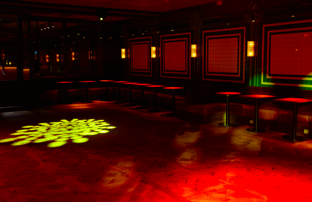 Stylish NEON194 Ballroom with red ambient lighting for networking and social events.