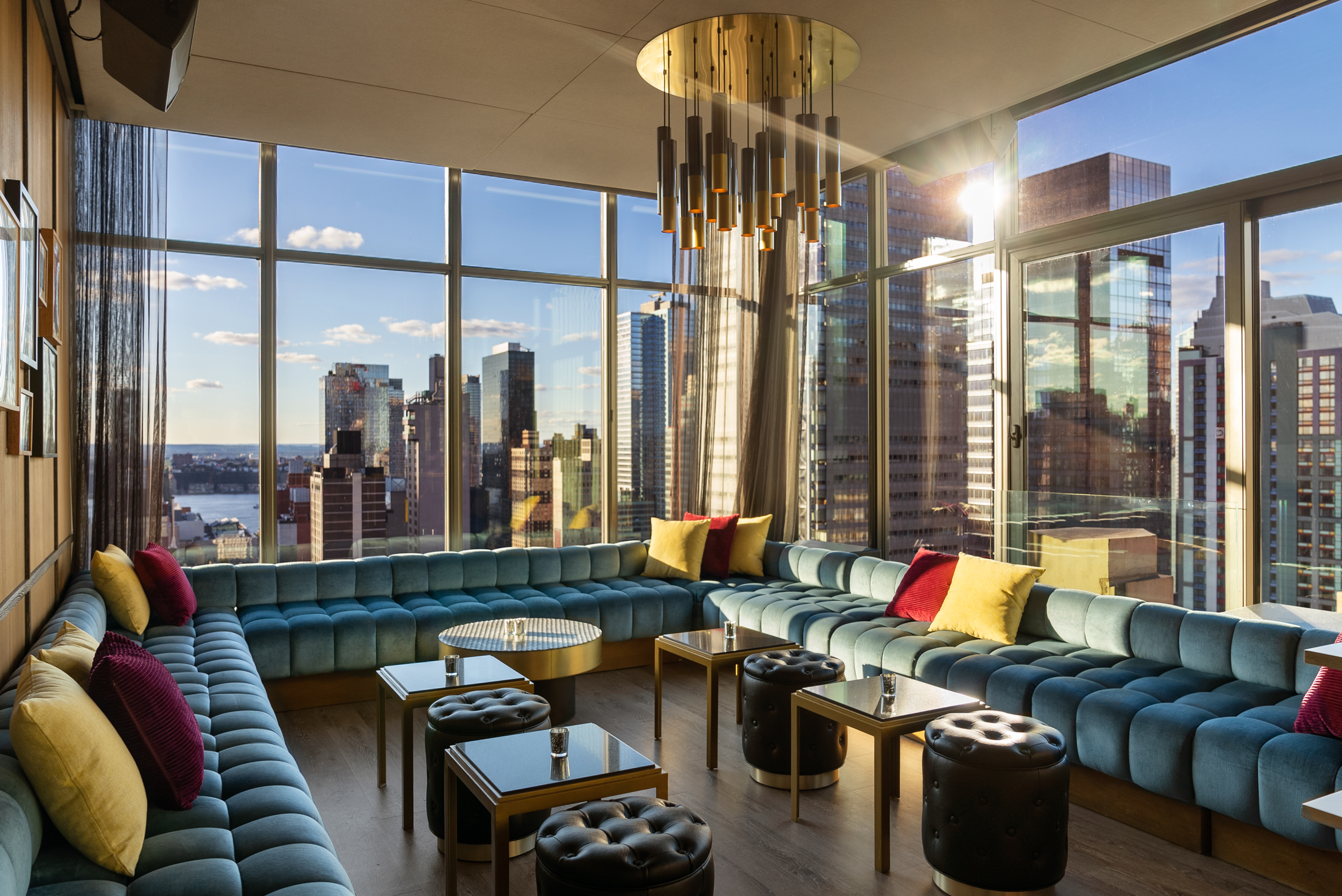 Stylish indoor lounge with panoramic city views, perfect for upscale events and gatherings.