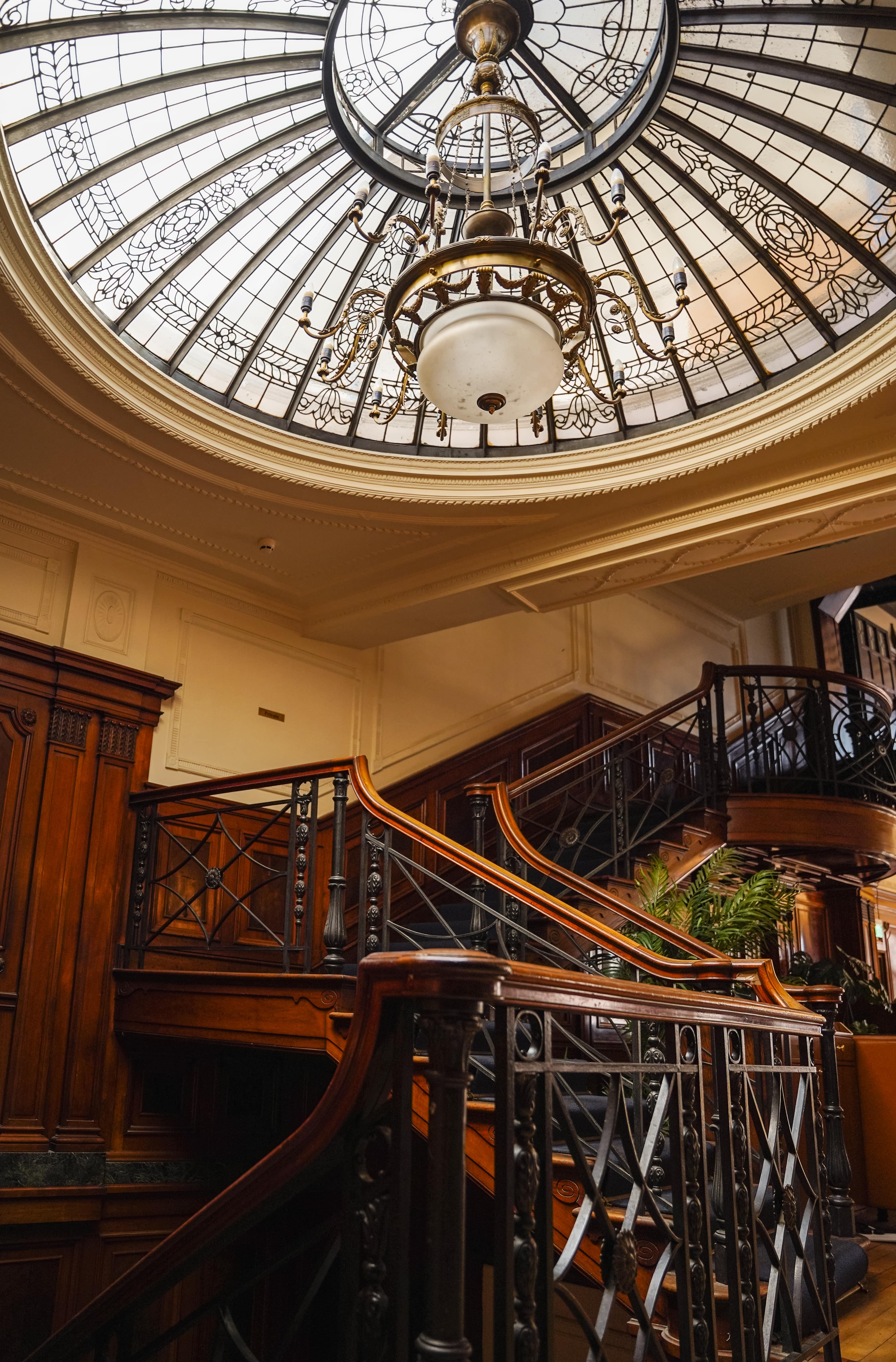 Elegant staircase with stained glass ceiling at Wonderbar, perfect for upscale events.