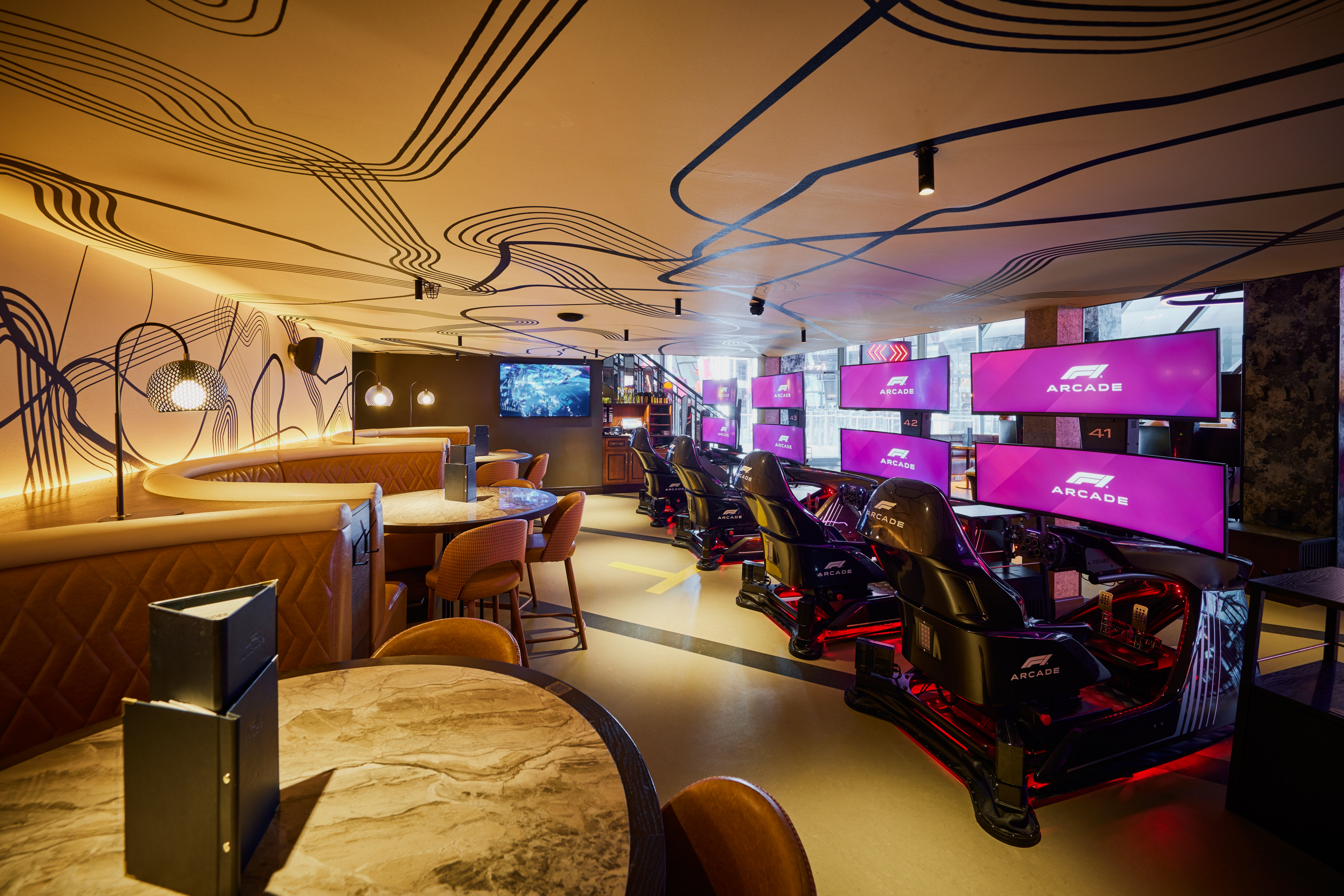 Modern event space with gaming stations for tech meetings and team-building events.