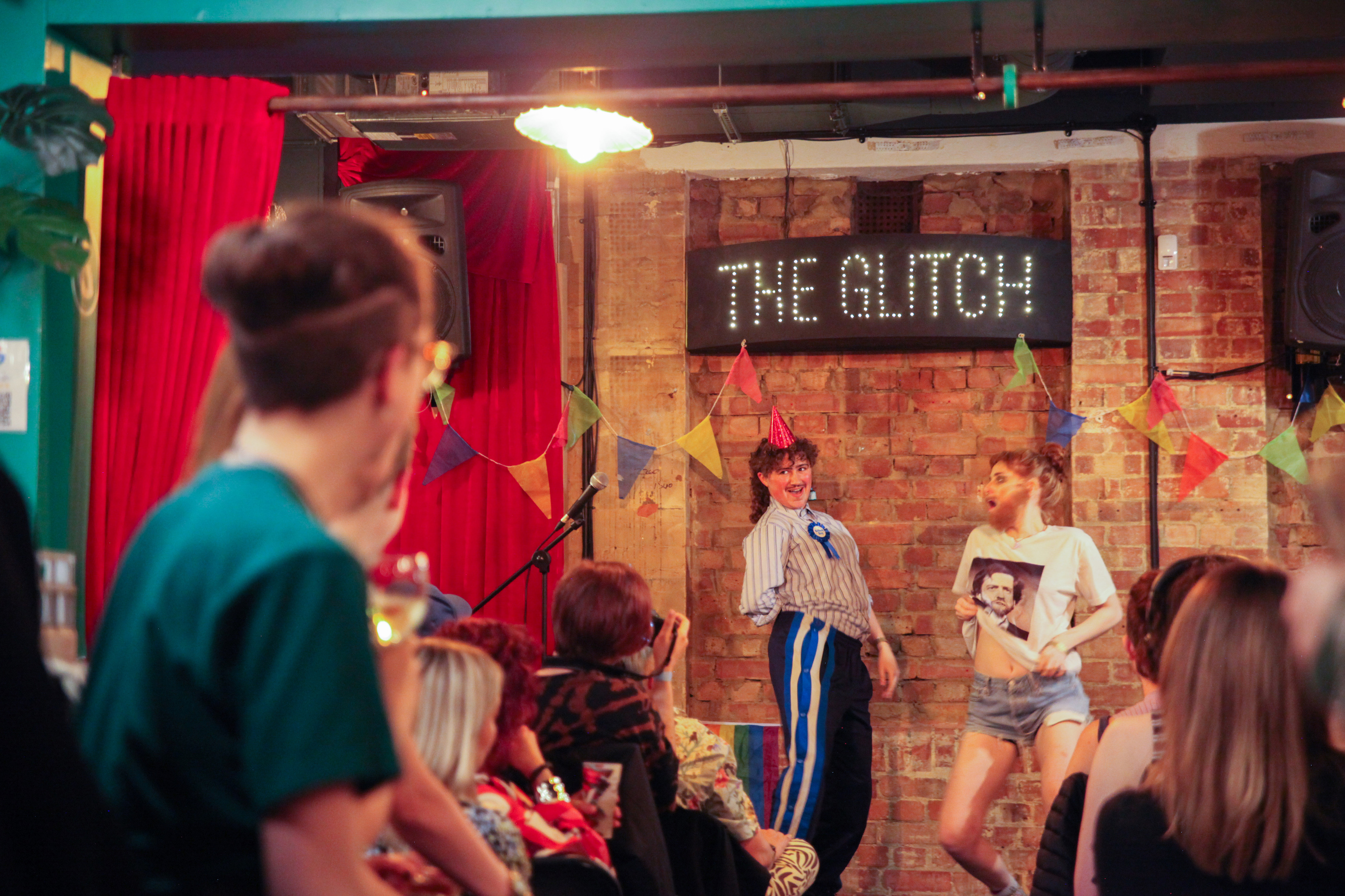 Vibrant event space at The Glitch bar with engaging performance and lively atmosphere.