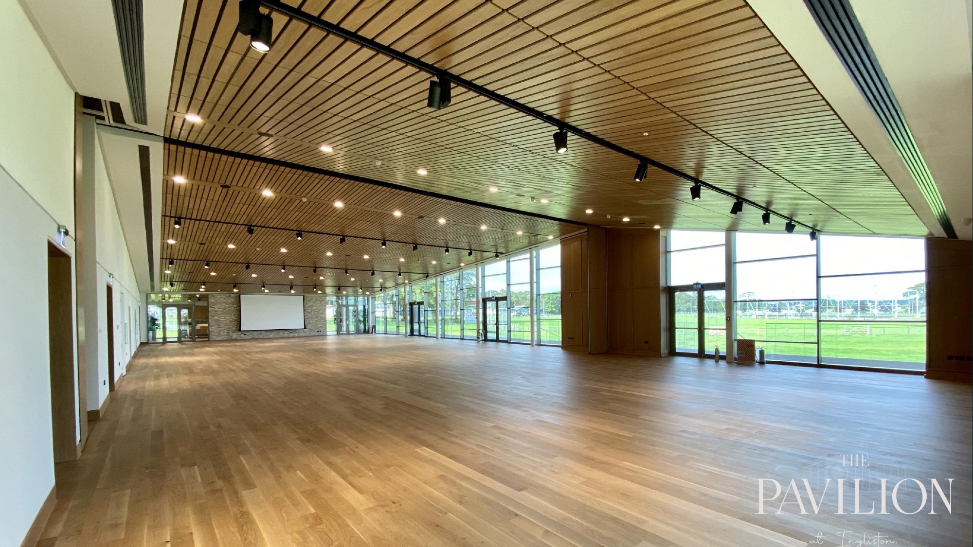 Modern event venue with wooden interior, ideal for corporate meetings and social gatherings.