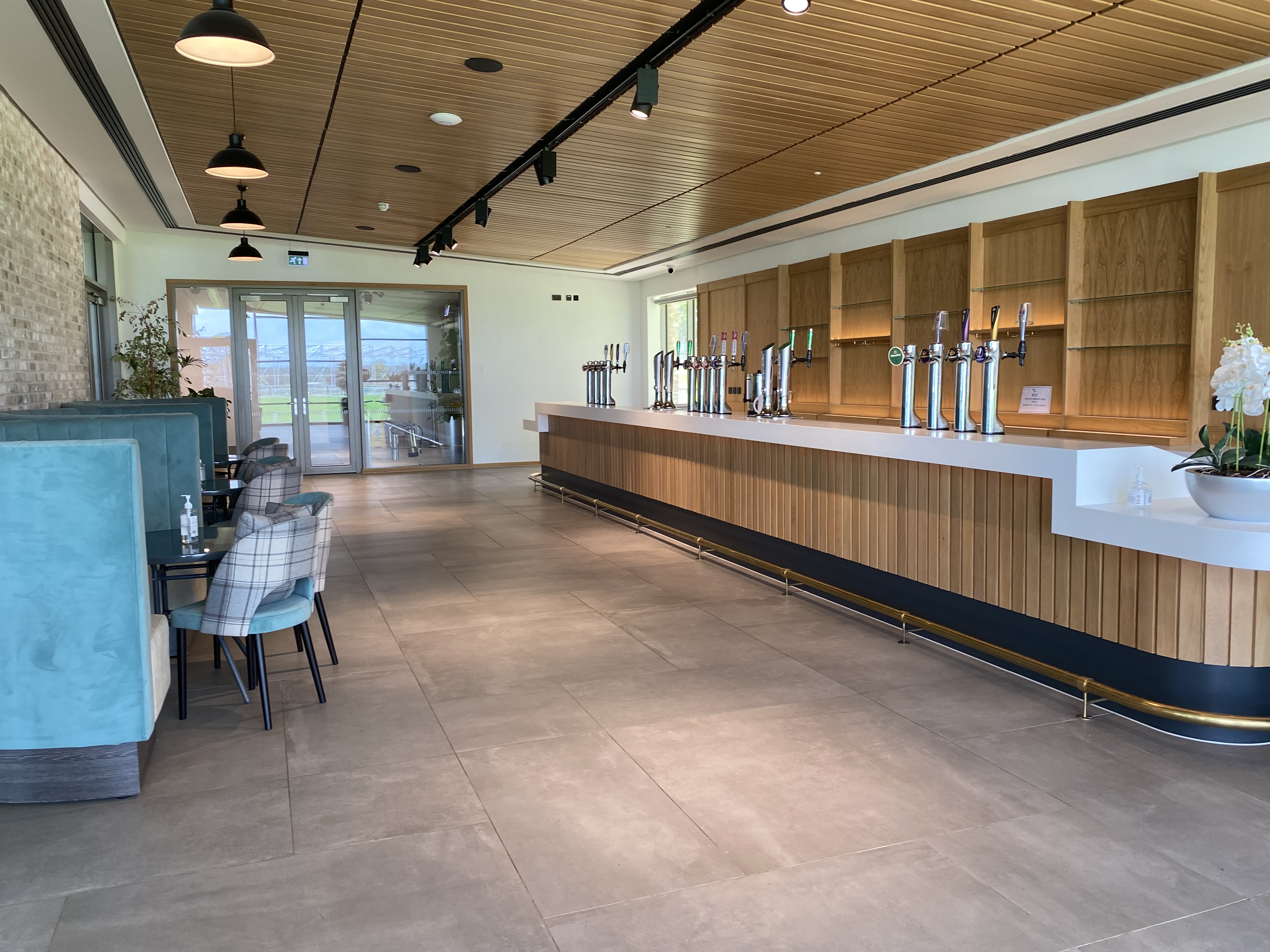 Modern event space at The Pavilion at Ingliston with sleek bar and natural light.