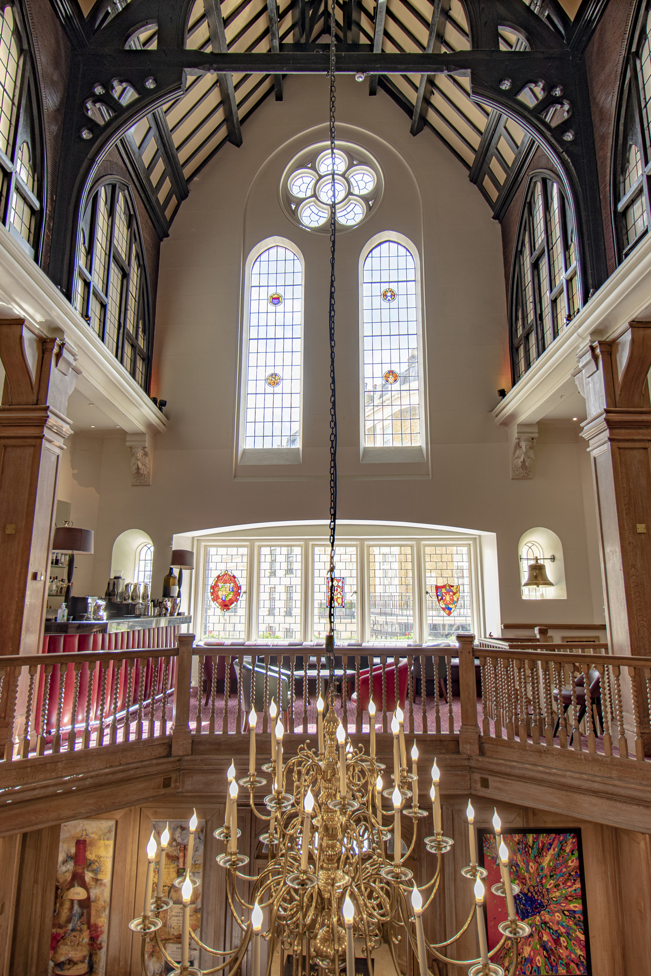 Elegant Main Dining Room at Mosimann's with stained glass, ideal for events and receptions.