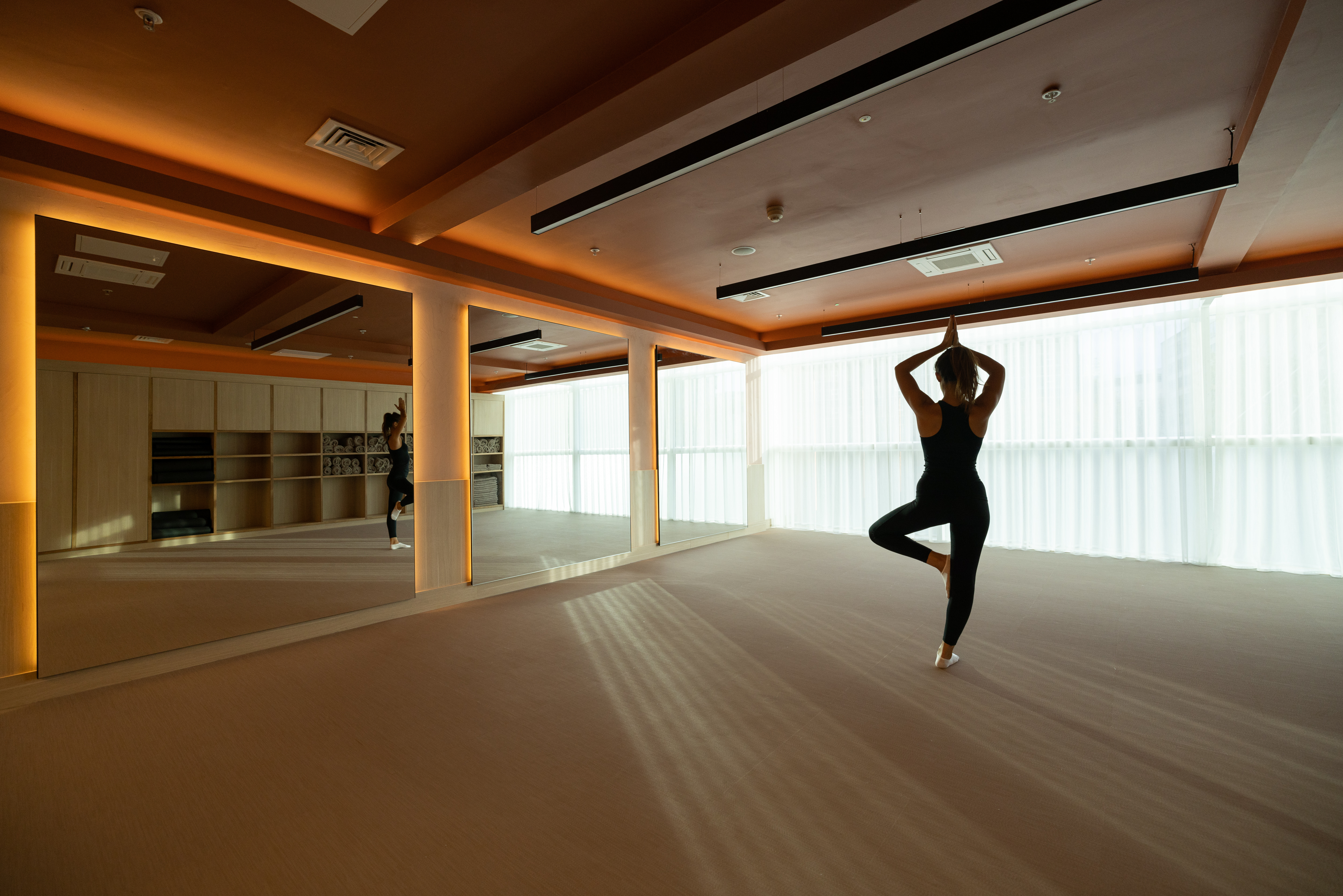 Serene yoga studio with mirrors at RE:TREAT, ideal for wellness workshops and retreats.