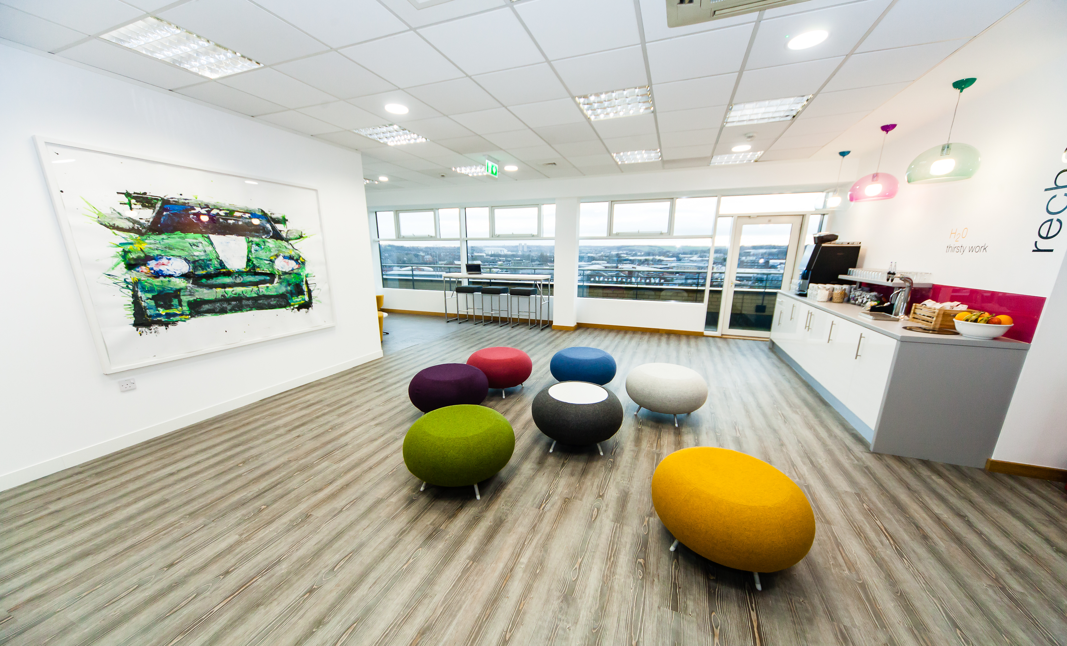 Modern meeting space in Leeds with colorful ottomans for creative collaboration.