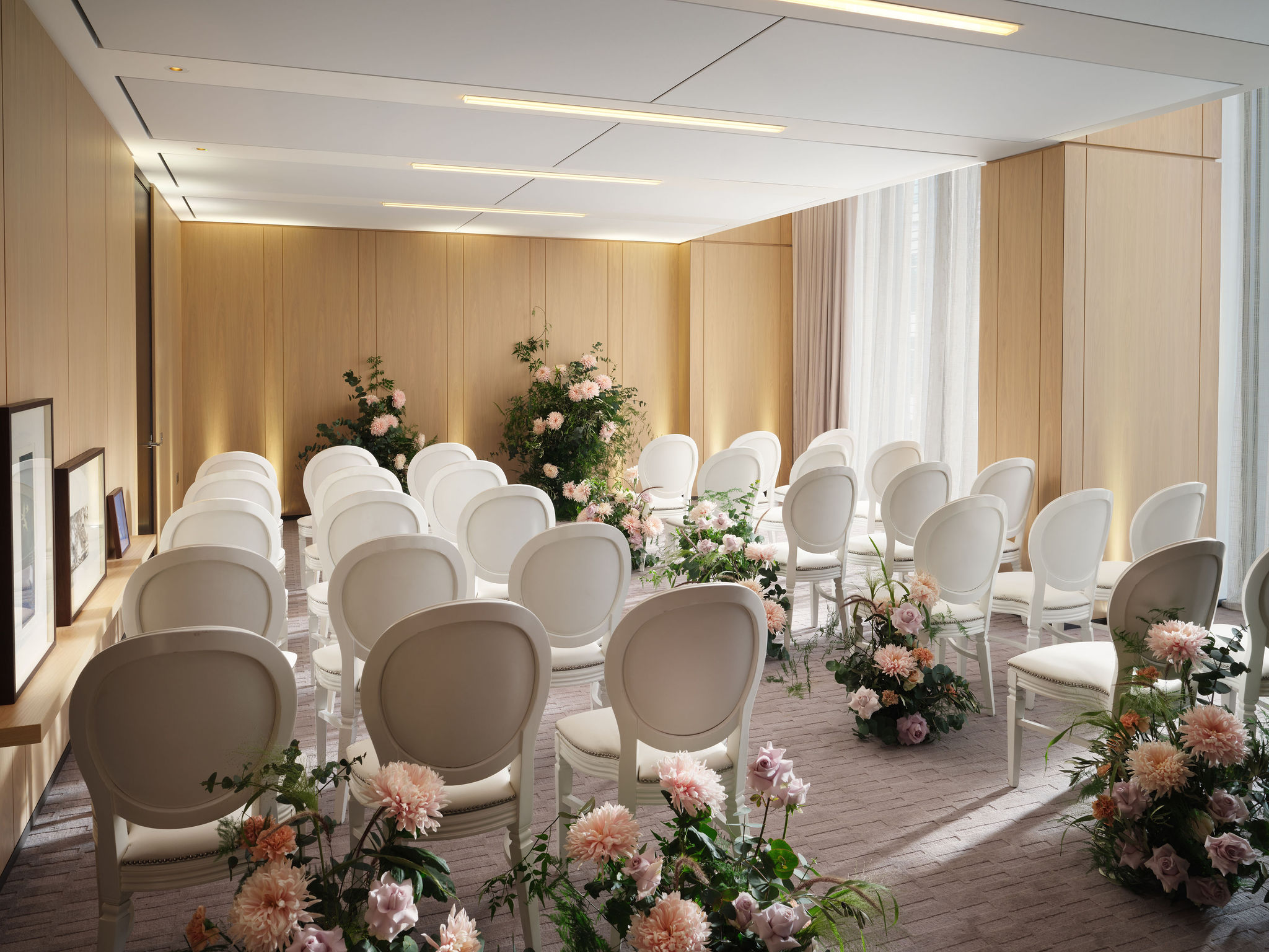 Four swans in elegant event space with floral decor, ideal for intimate gatherings.