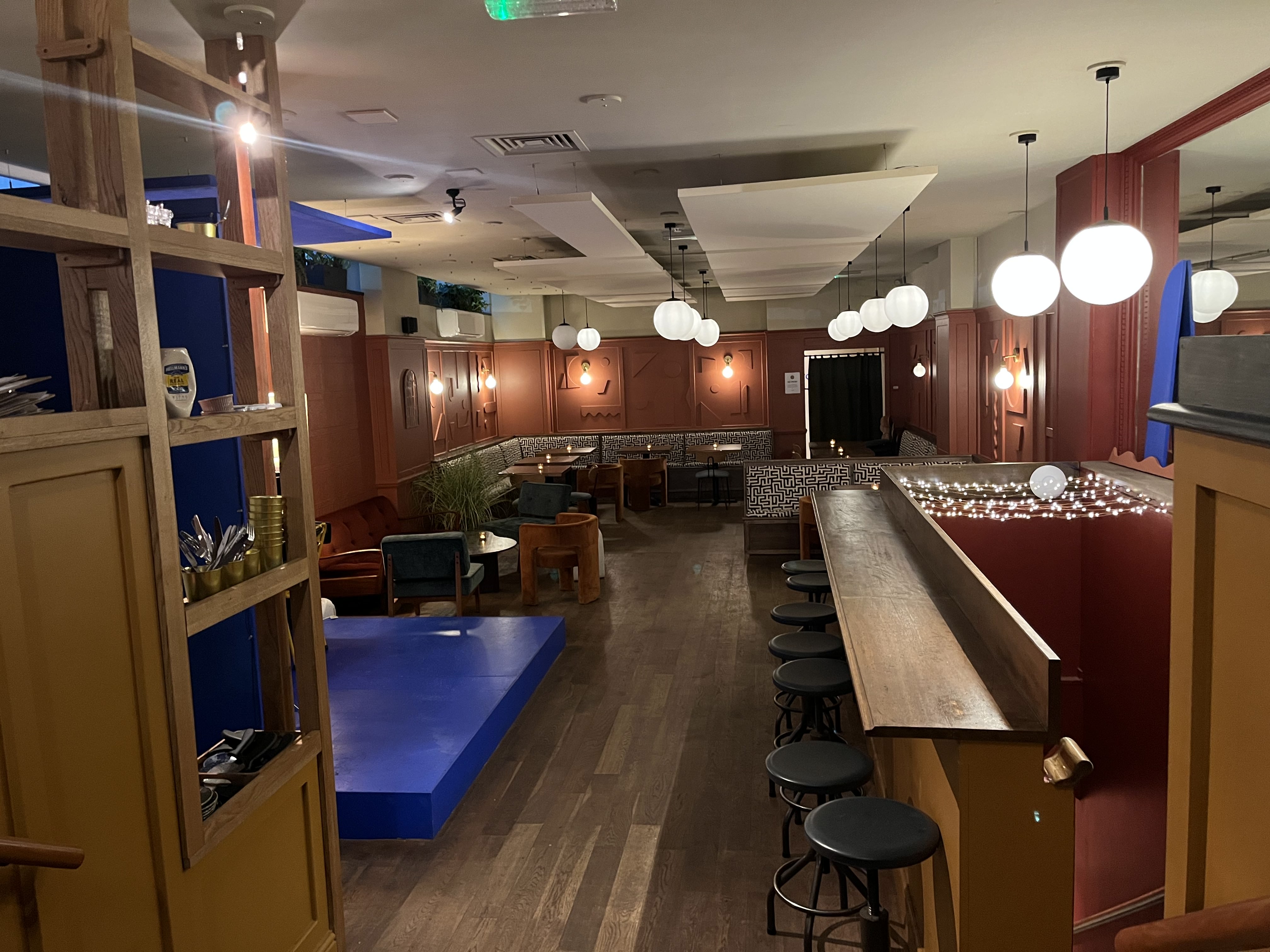 Versatile event space with warm wood tones, ideal for networking and gatherings.