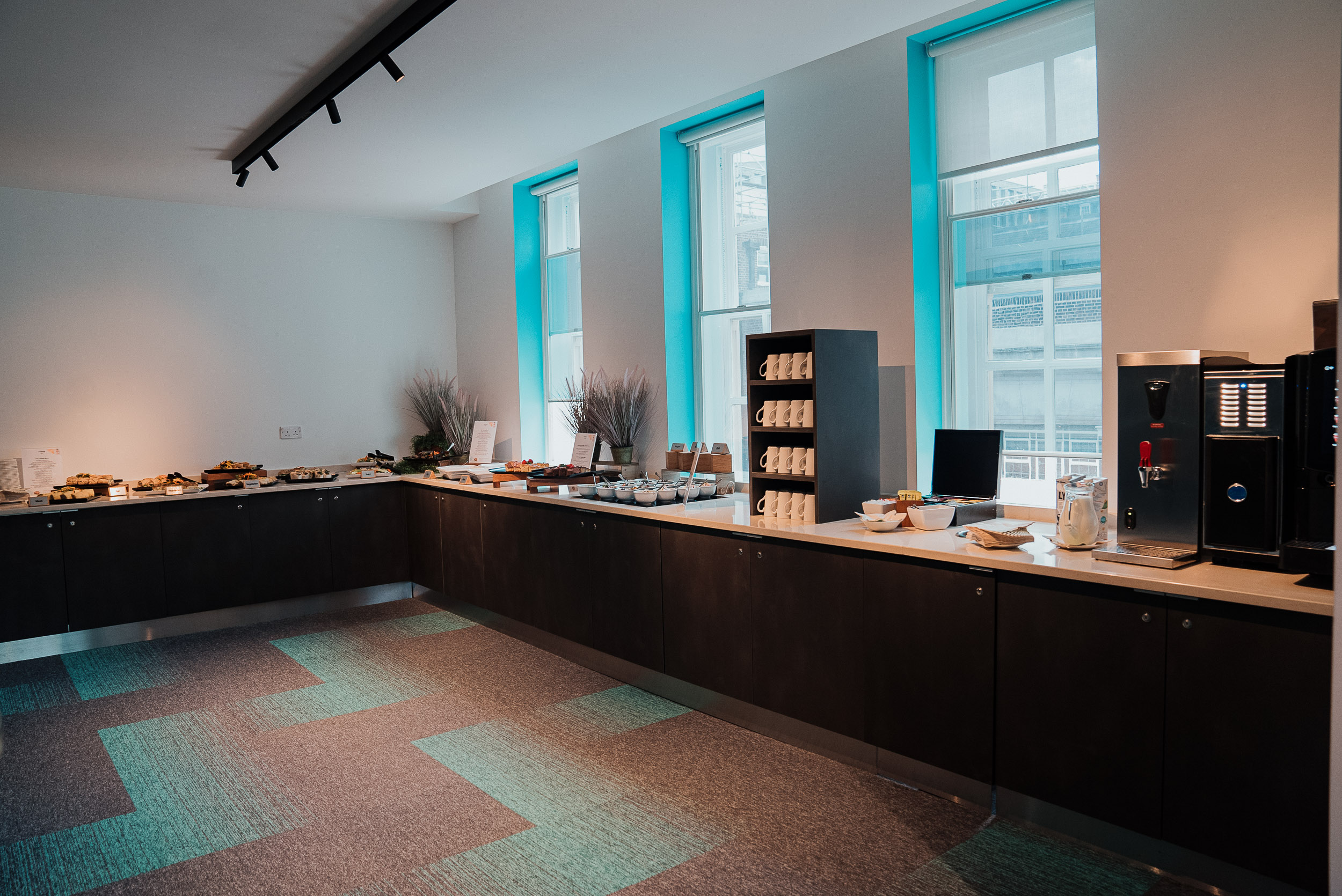 "Refreshment area for meeting with food options and natural light at Friends House."