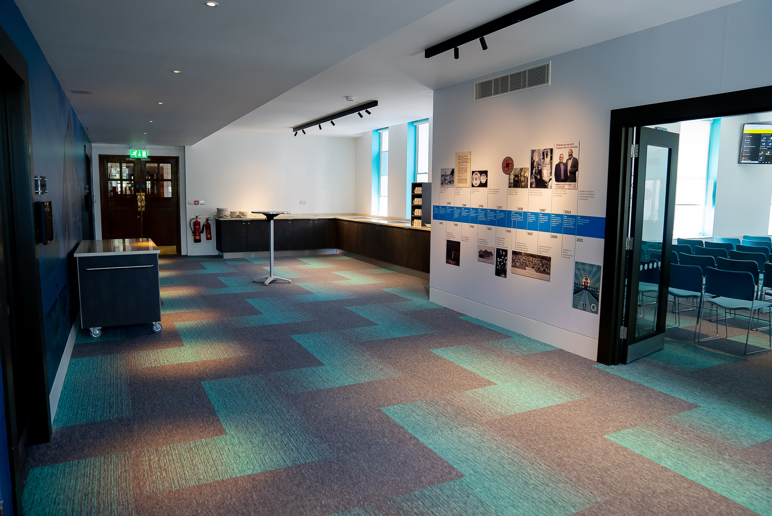 Modern event space with vibrant carpet, ideal for meetings and networking.