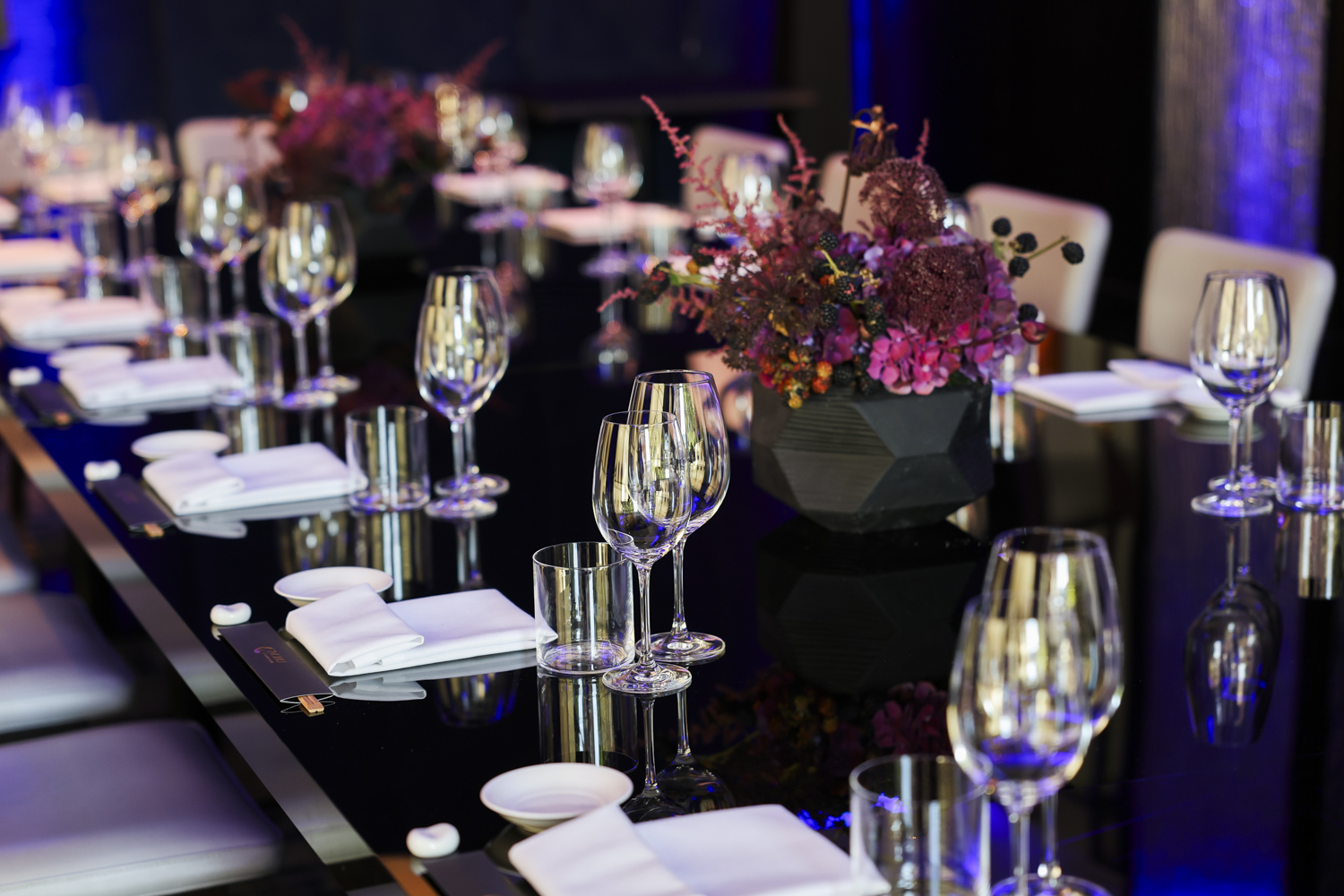 Elegant dining setup at Nobu Bar, featuring floral centerpieces for upscale events.