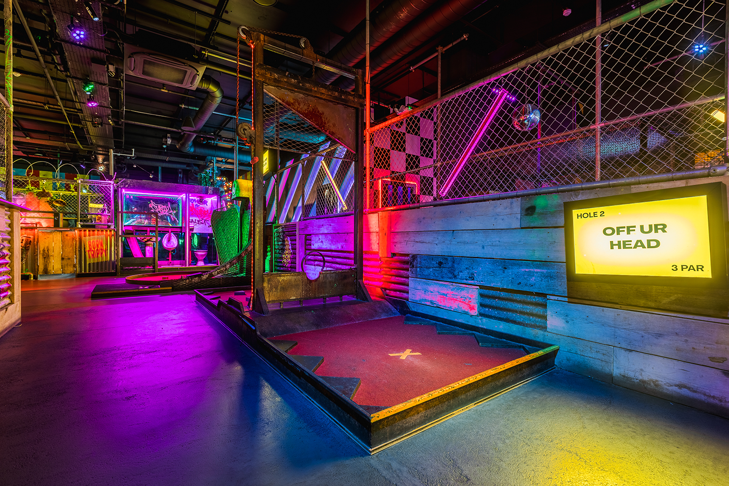 Dirk at Junkyard Golf Club, vibrant neon decor for corporate events and celebrations.