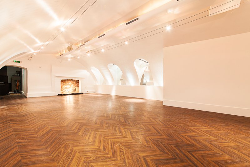 Elegant Adam House Event Space with wooden flooring and natural light for gatherings.