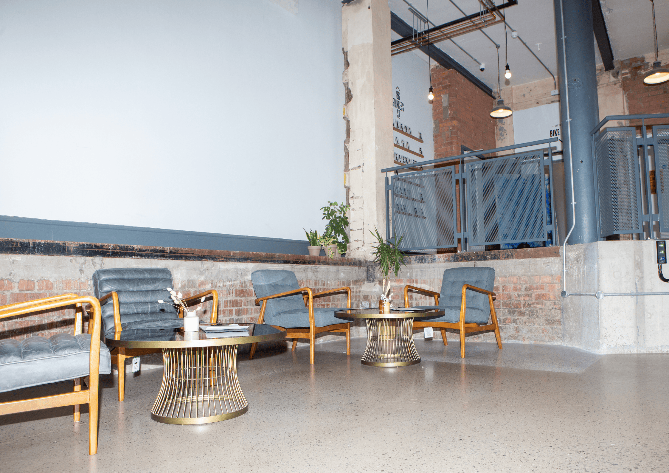 Stylish SEESAW foyer with modern seating and gold tables for networking events.