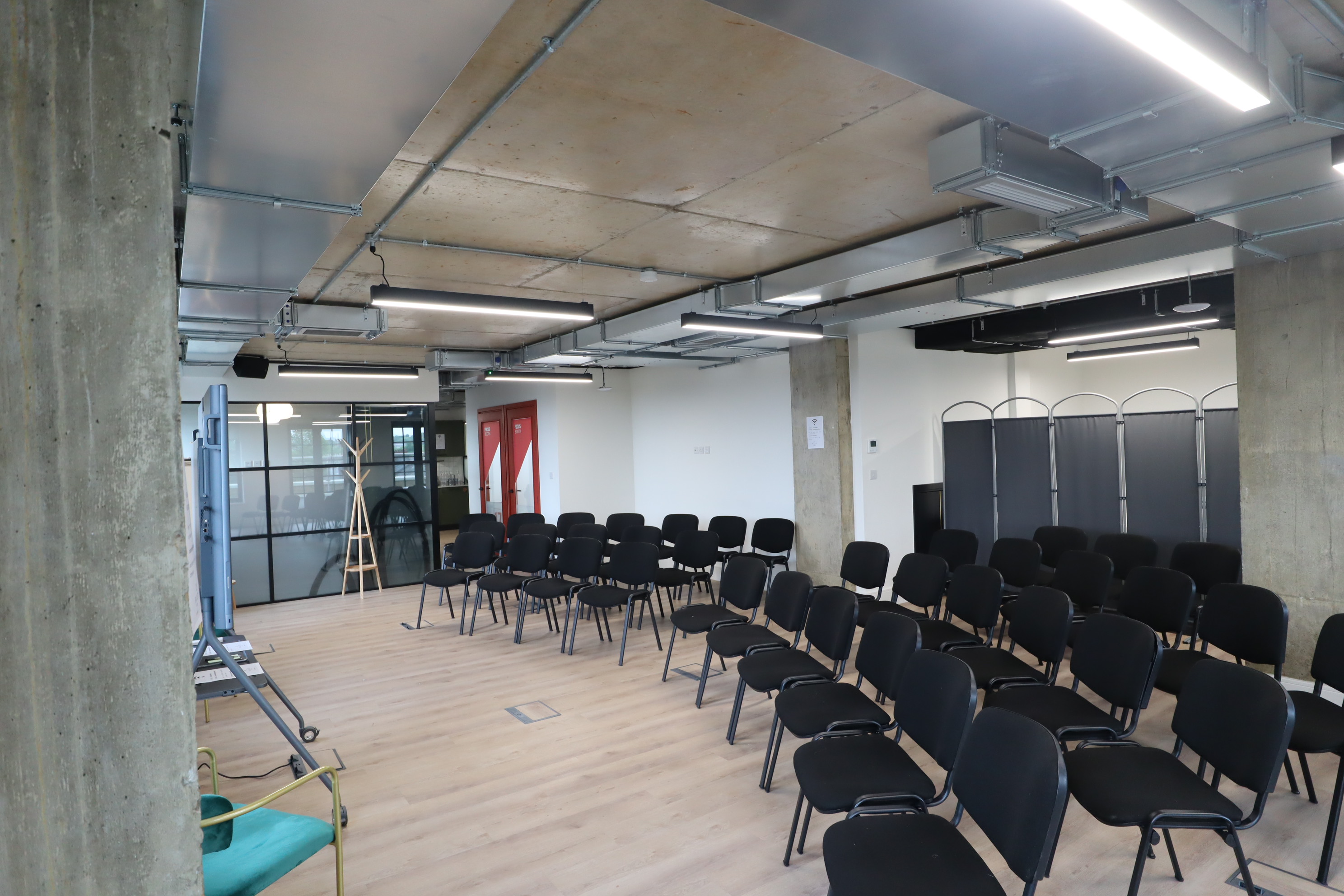 Event Terrace & Suite at Riley Studios, modern meeting space with black chairs, ideal for workshops.