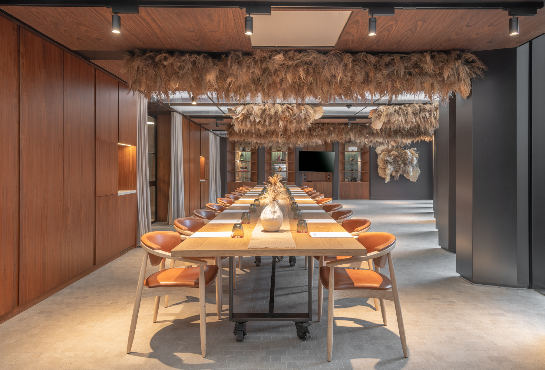 Modern meeting space at Dunstan Den, featuring a long wooden table for brainstorming sessions.