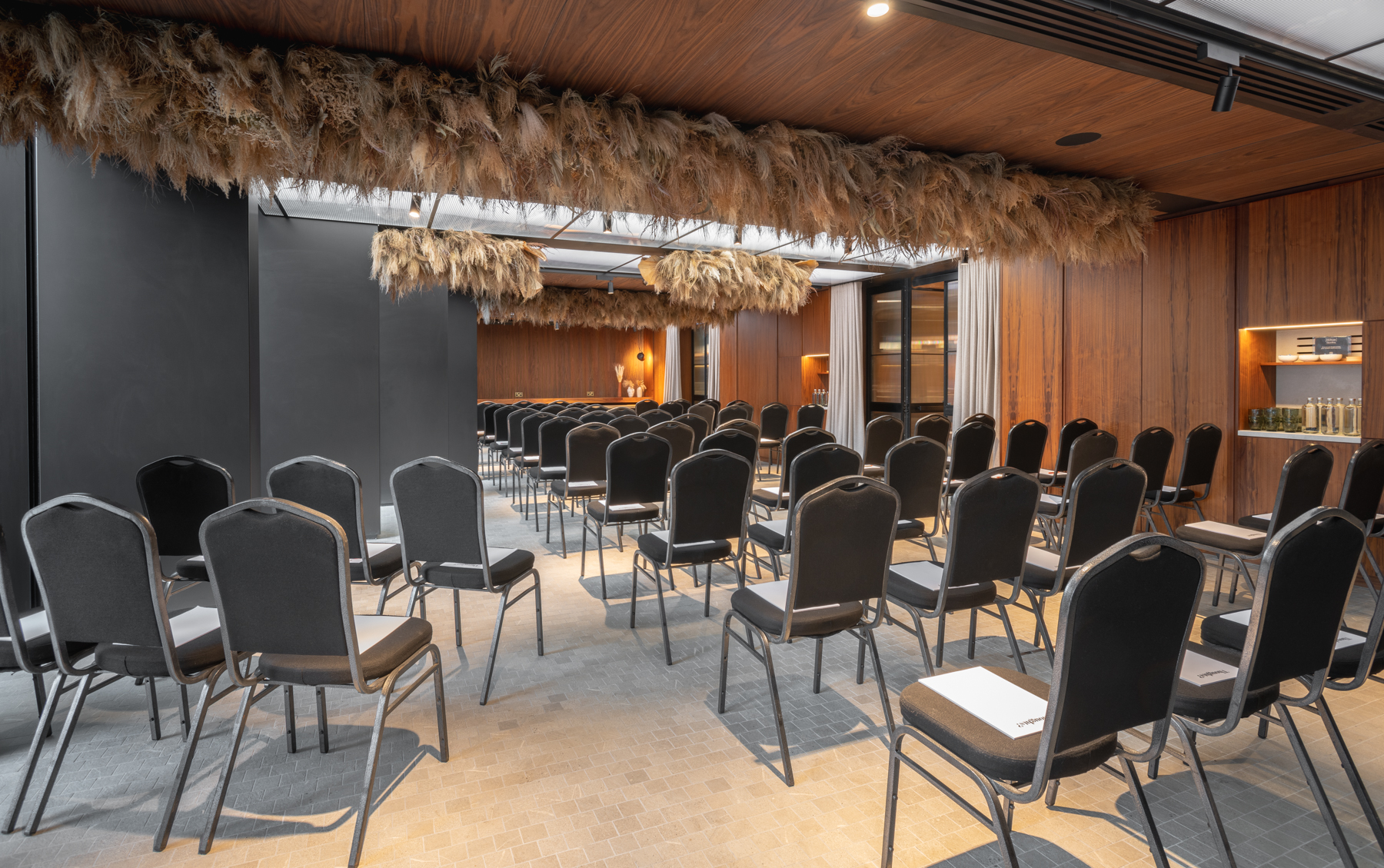 Modern event space with black chairs, ideal for corporate meetings and workshops.