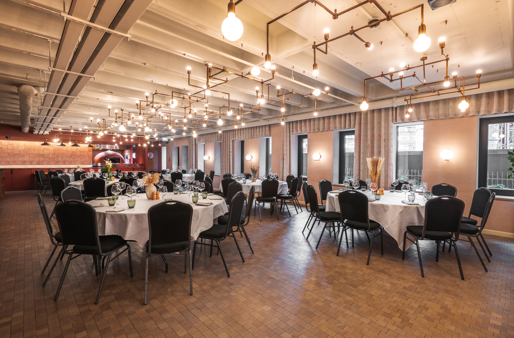 Elegant event space with round tables, ideal for formal dinners and networking in London.