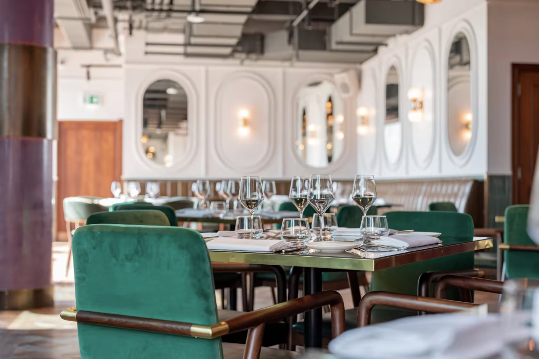 Stylish dining space with plush green chairs for corporate events in Wagtail London.