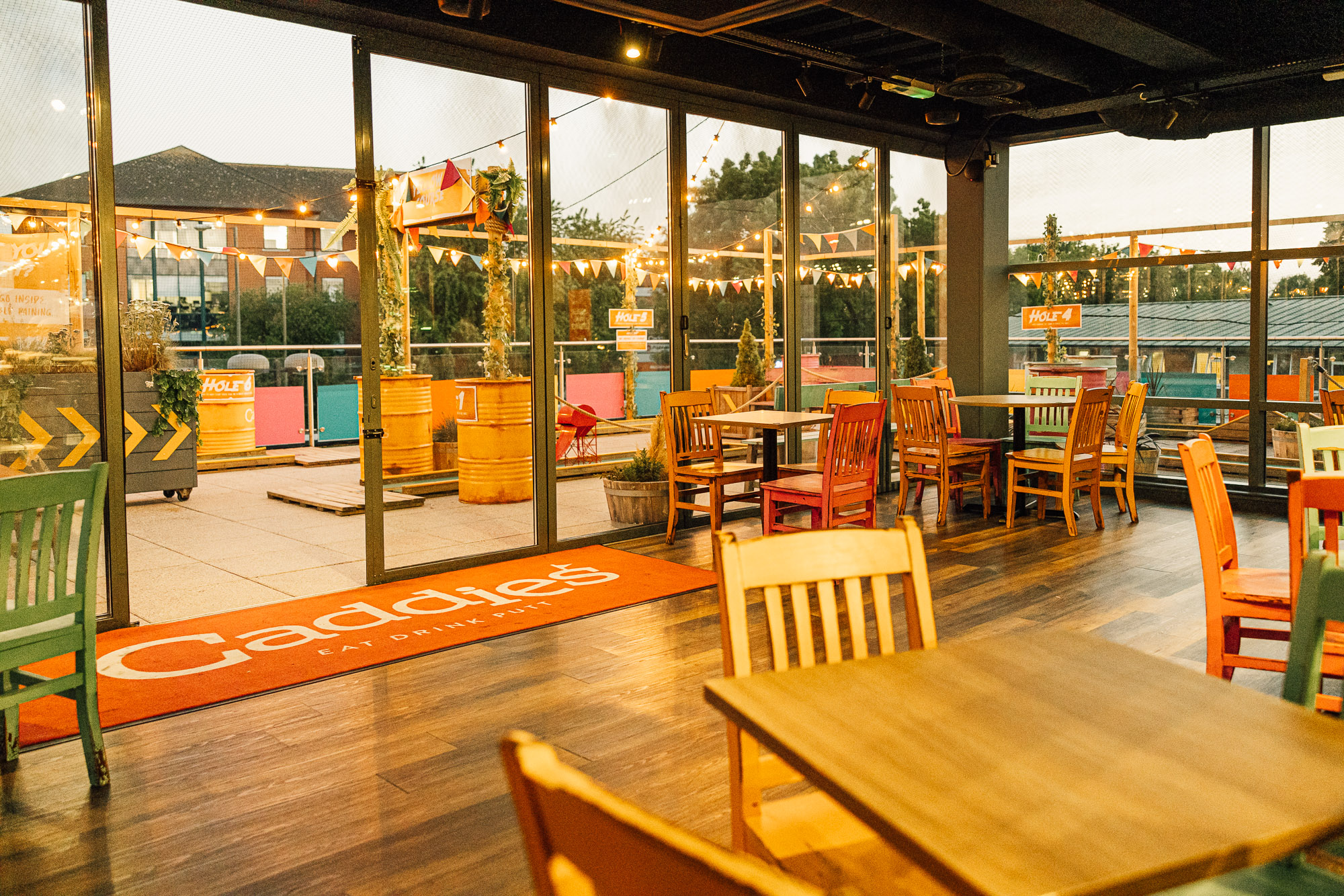 Vibrant event space in Caddies Crawley with colorful seating for gatherings and networking.