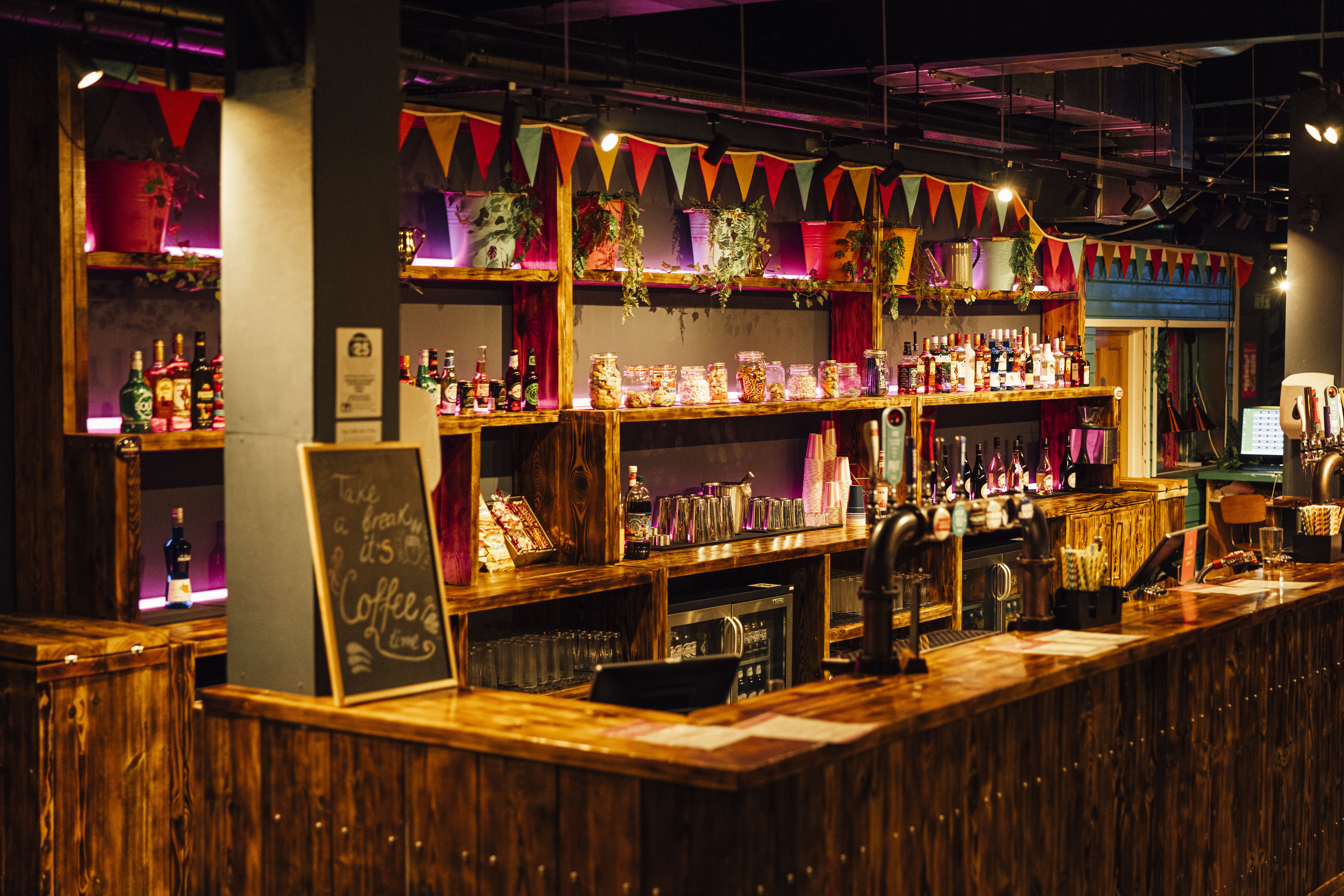 Vibrant bar setup with rustic decor for events at Caddies Crawley, ideal for gatherings.