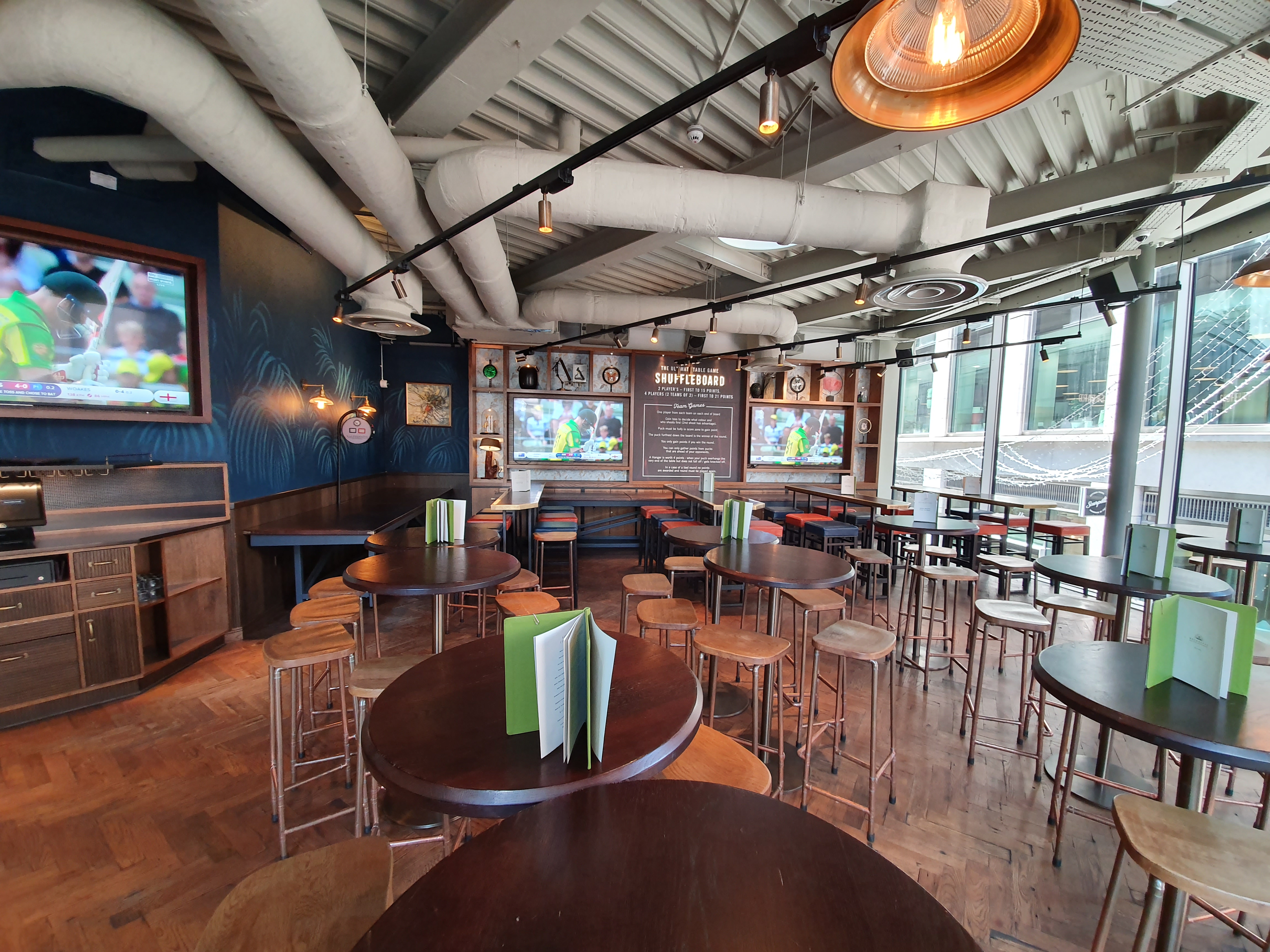 Modern Sports Lounge in Broadleaf with high-top tables for events and networking.