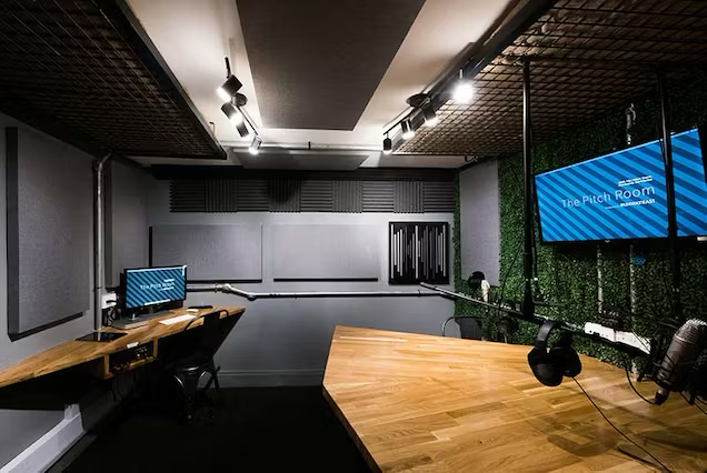 Modern meeting space with wooden table for pitches and virtual events in Runway East Soho.