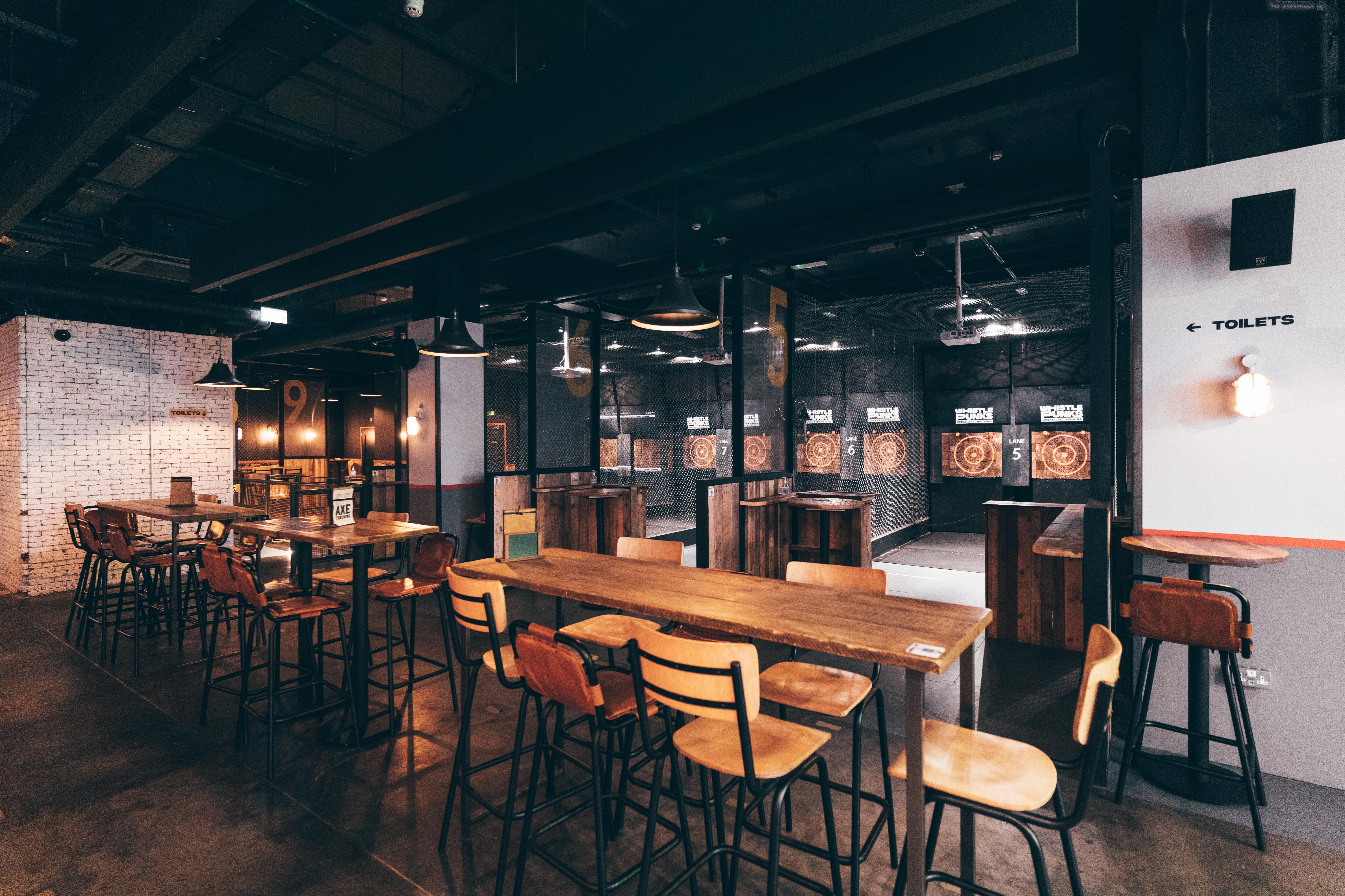 Venue hire at Whistle Punks Urban Axe Throwing, featuring industrial decor and dartboards.