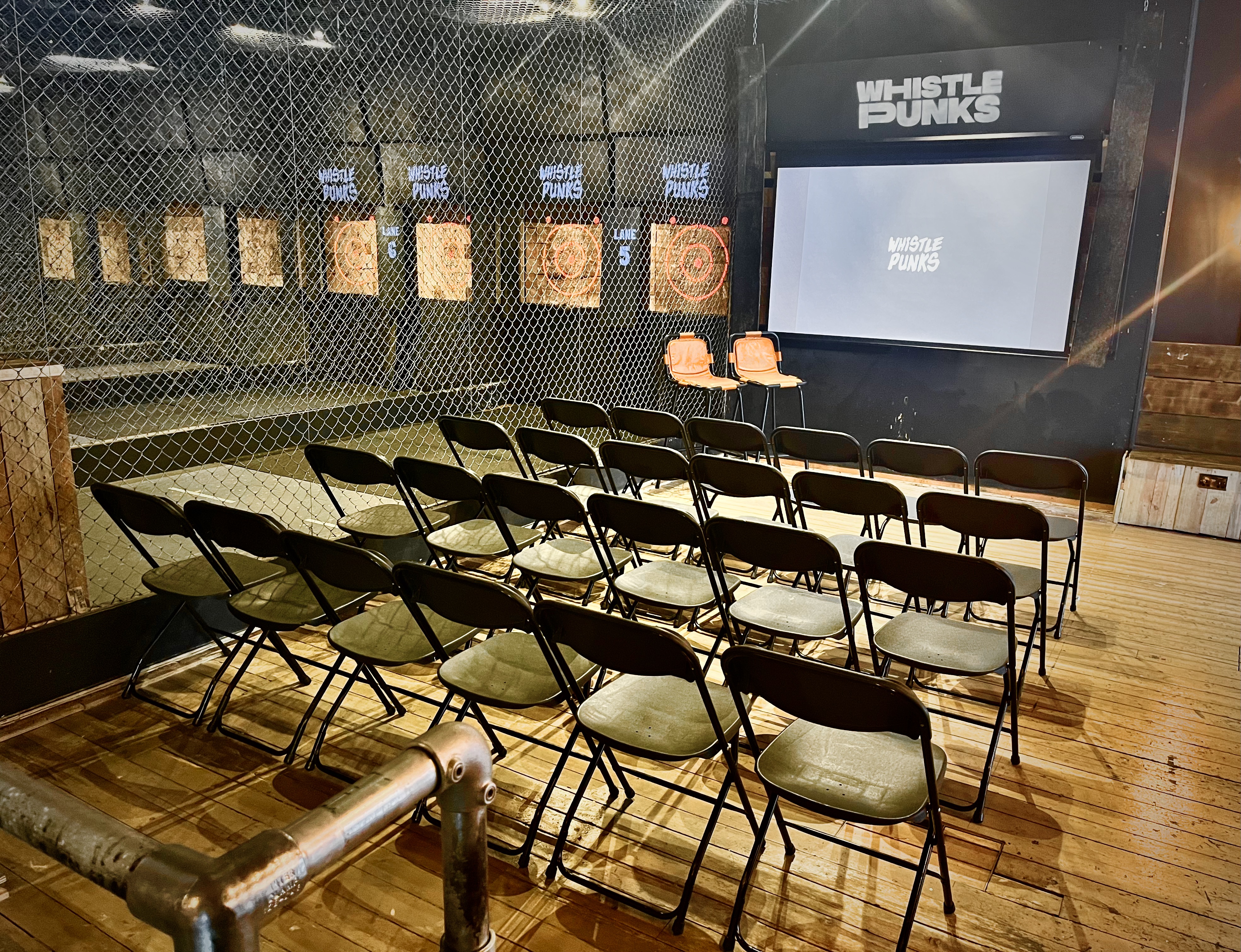 Venue hire at Whistle Punks: minimalist space with black chairs for workshops and presentations.