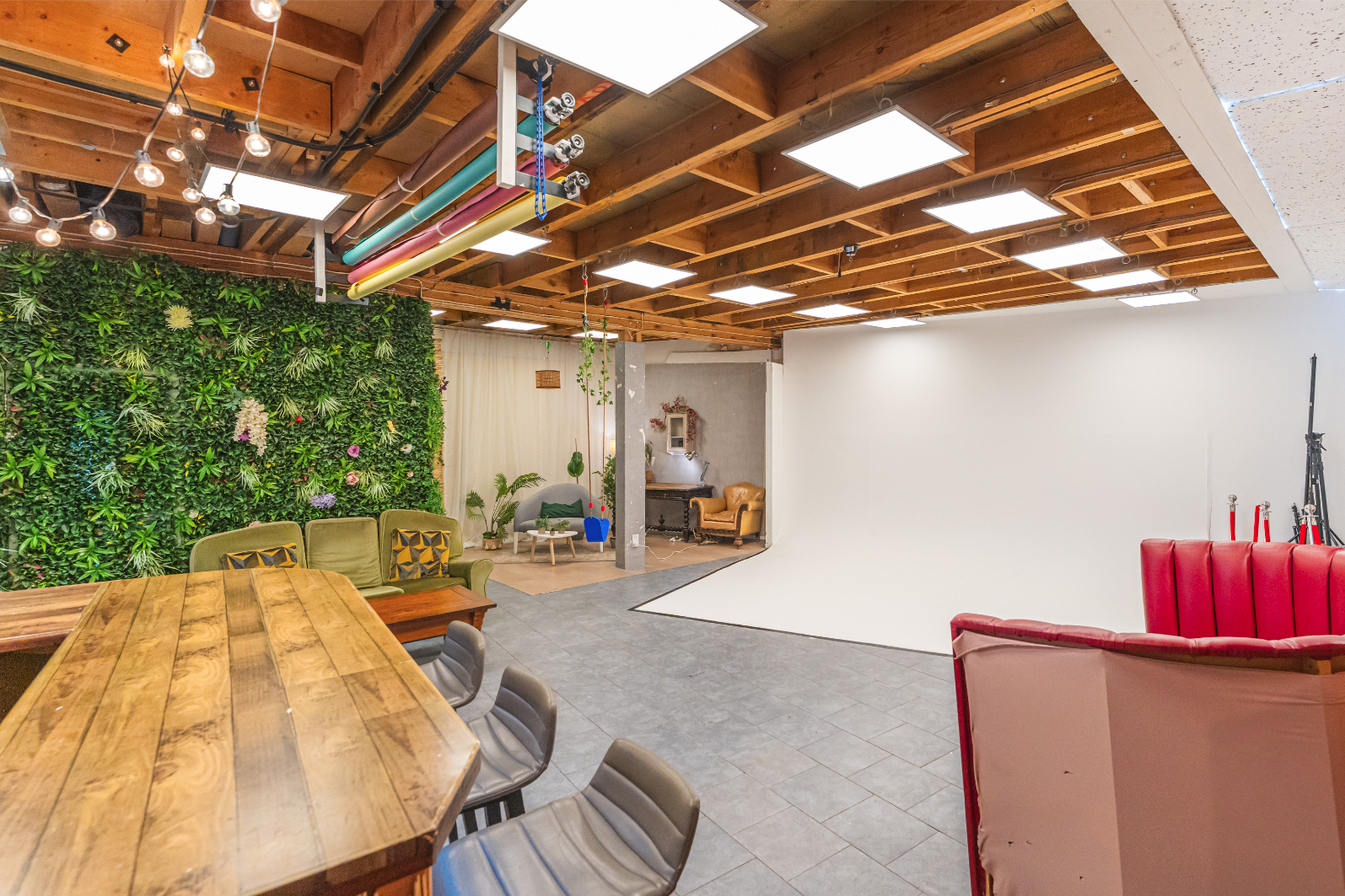 Versatile event space with green wall, ideal for meetings and workshops at 6 Degrees Studios.