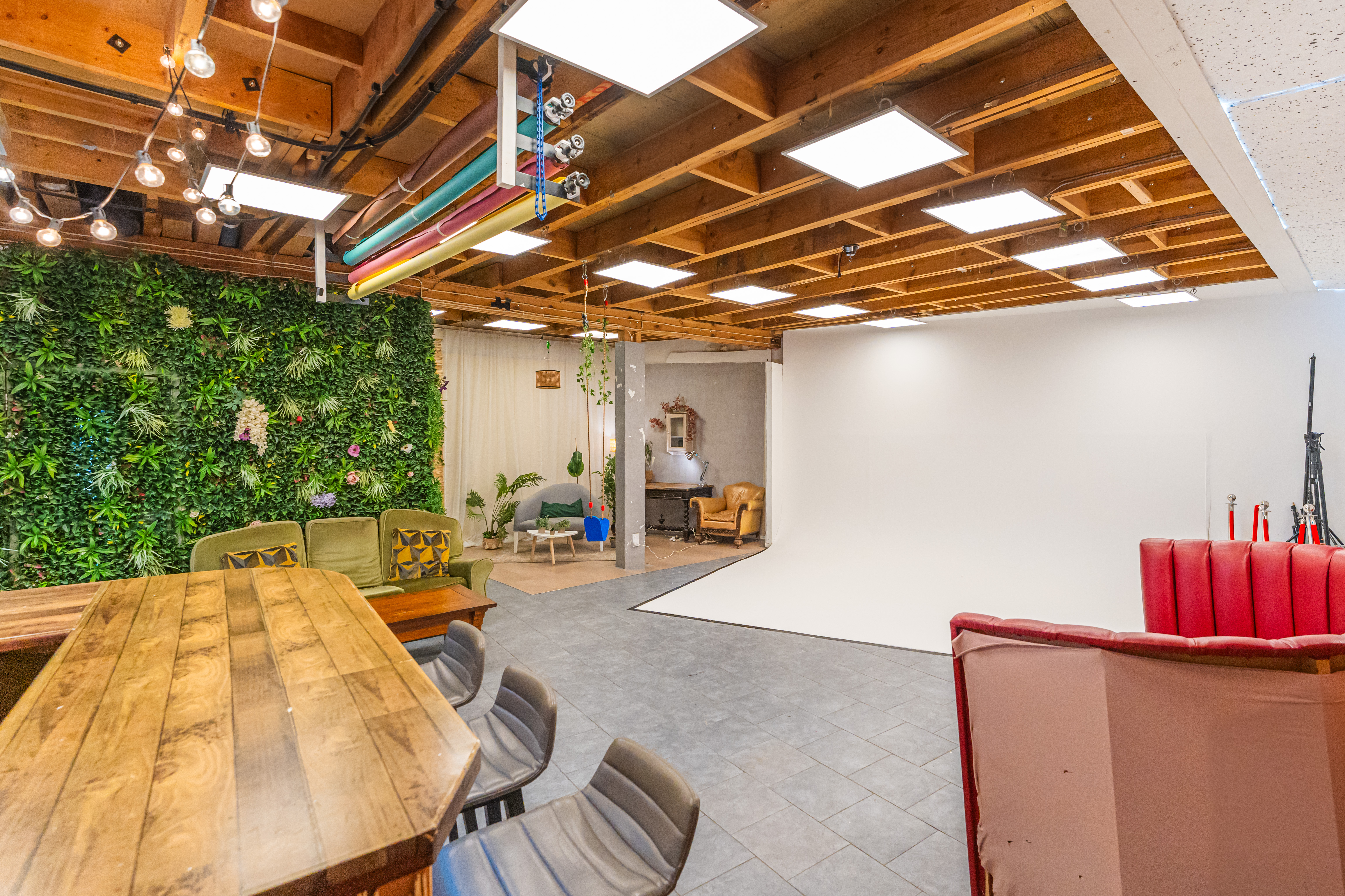 Versatile event space with green wall, perfect for meetings and workshops at 6 Degrees Studios.