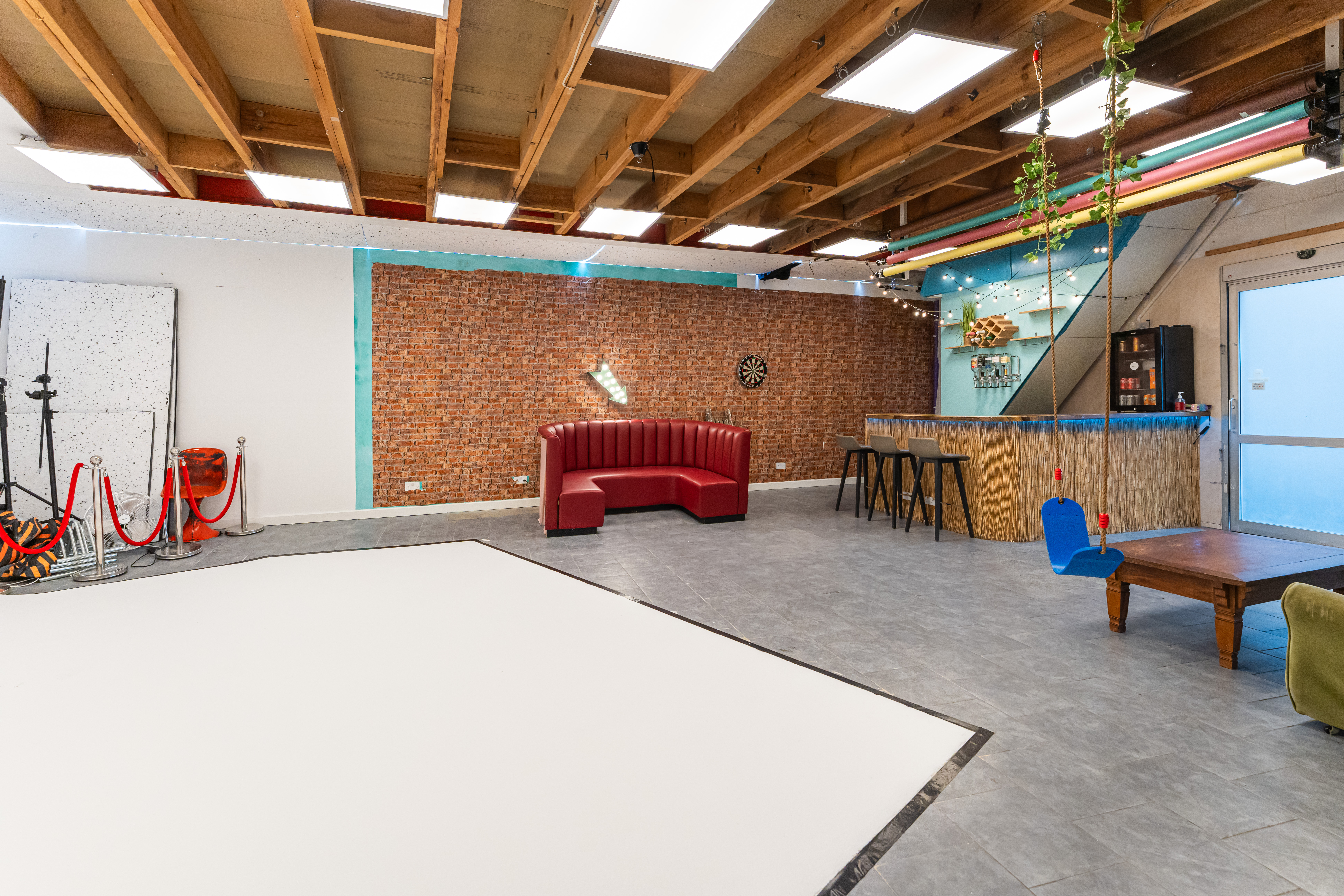 Versatile event space at 6 Degrees Studios with exposed beams, ideal for meetings and gatherings.