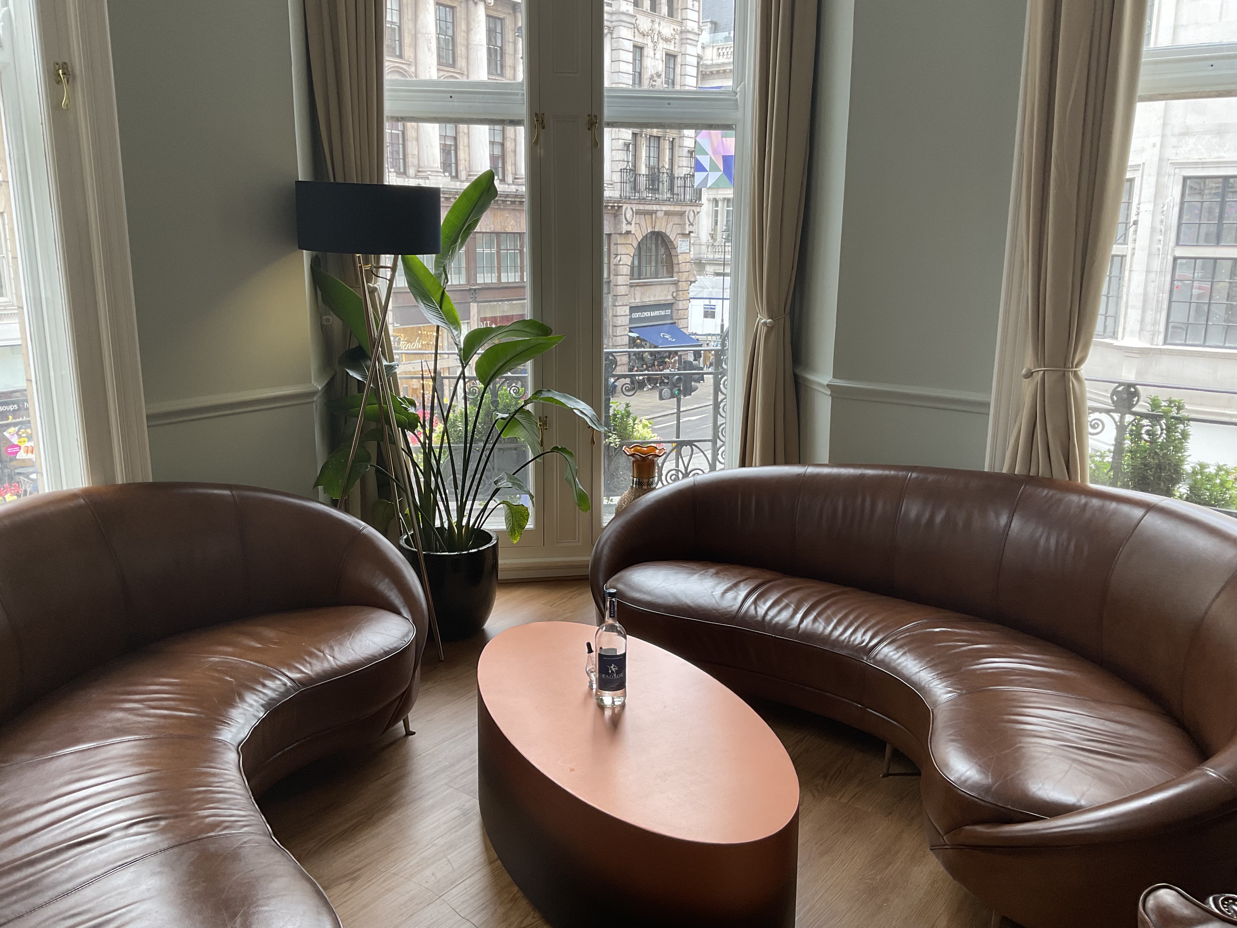 Stylish whisky lounge with curved leather sofas for networking events and meetings.